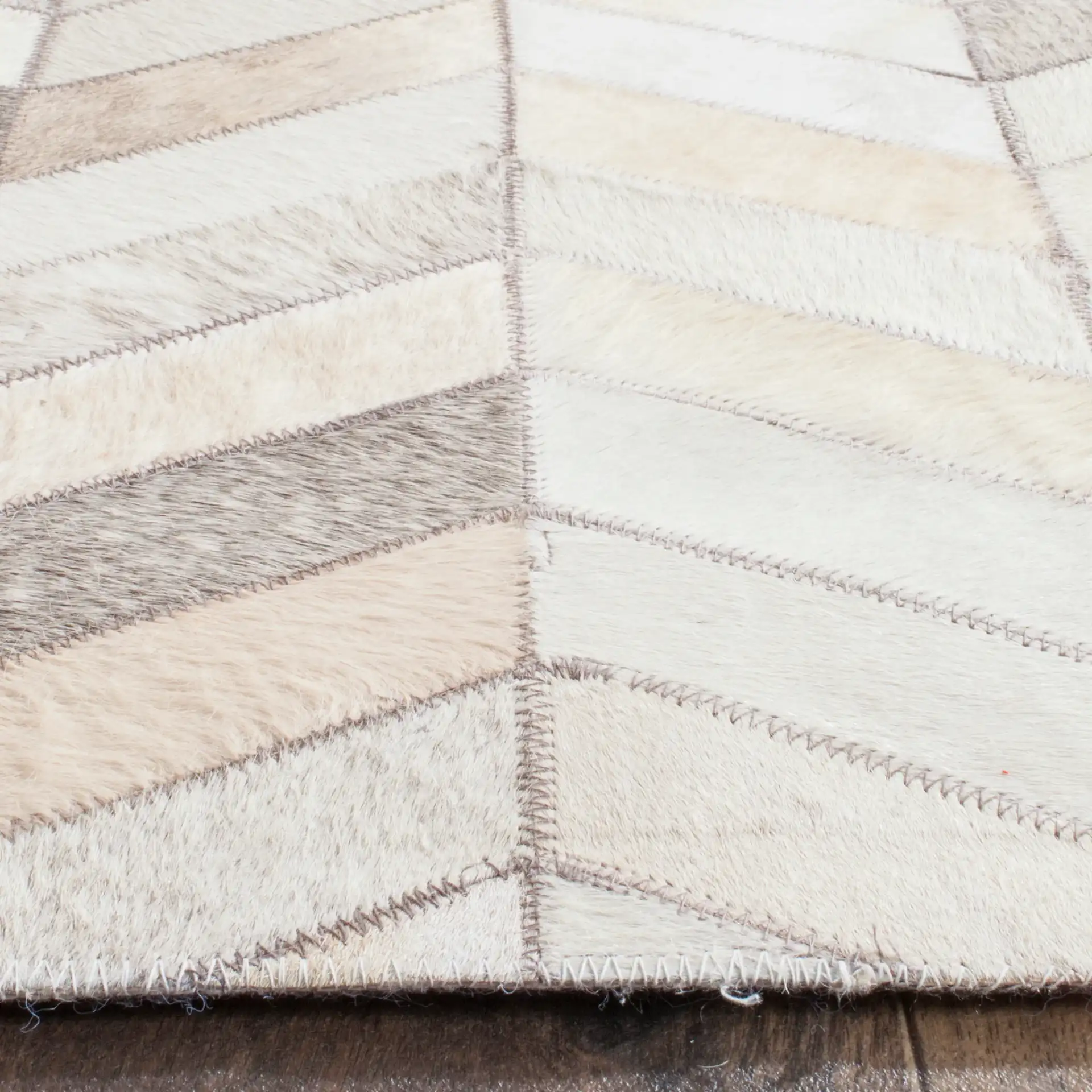 Studio Leather Herringbone Patchwork Hand-Woven Rug in Gray in a styled room