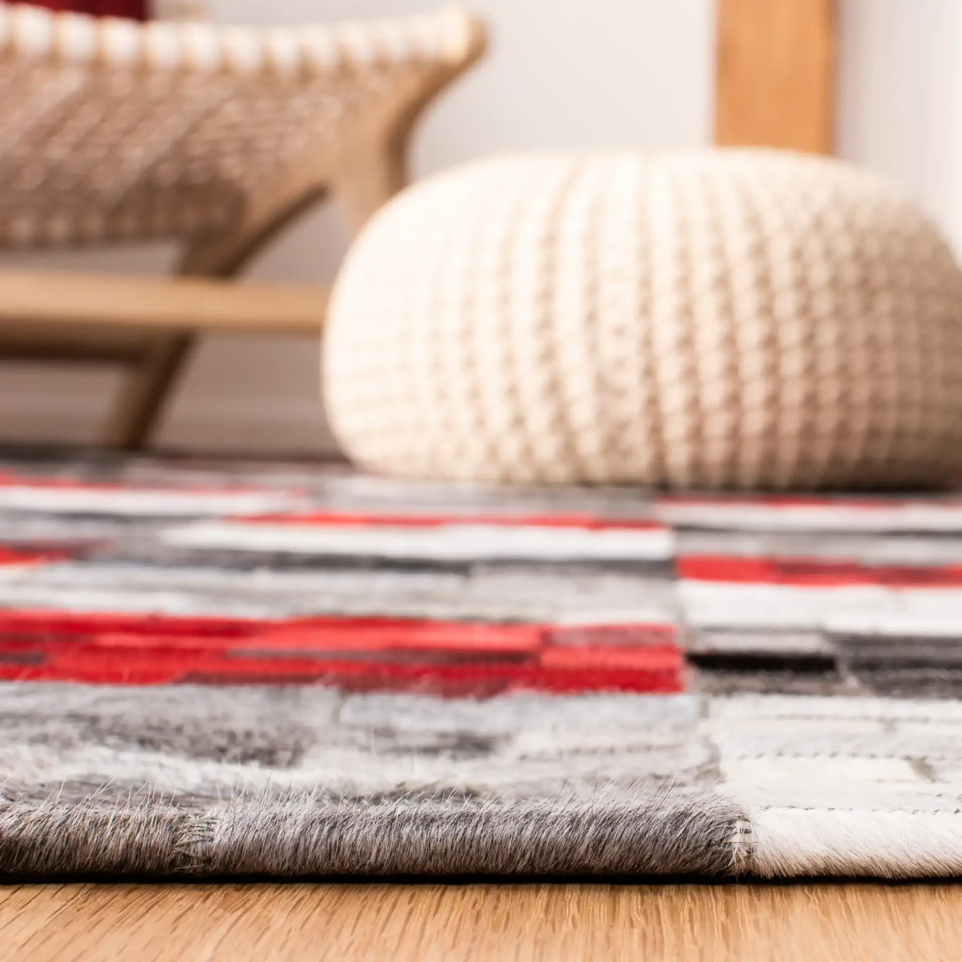 Studio Leather Checkerboard Patchwork Hand-Woven Rug in Gray / Red in a styled room