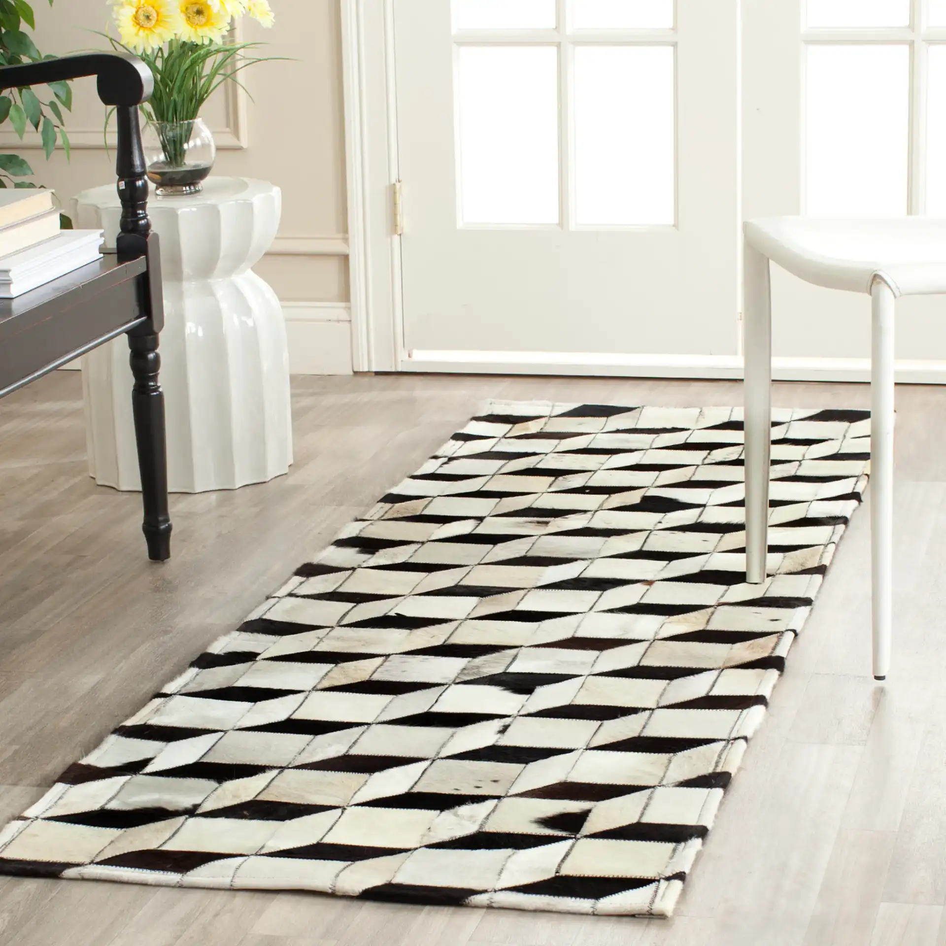 Studio Leather Patchwork Cubes Rug in Black / Gray in a styled room