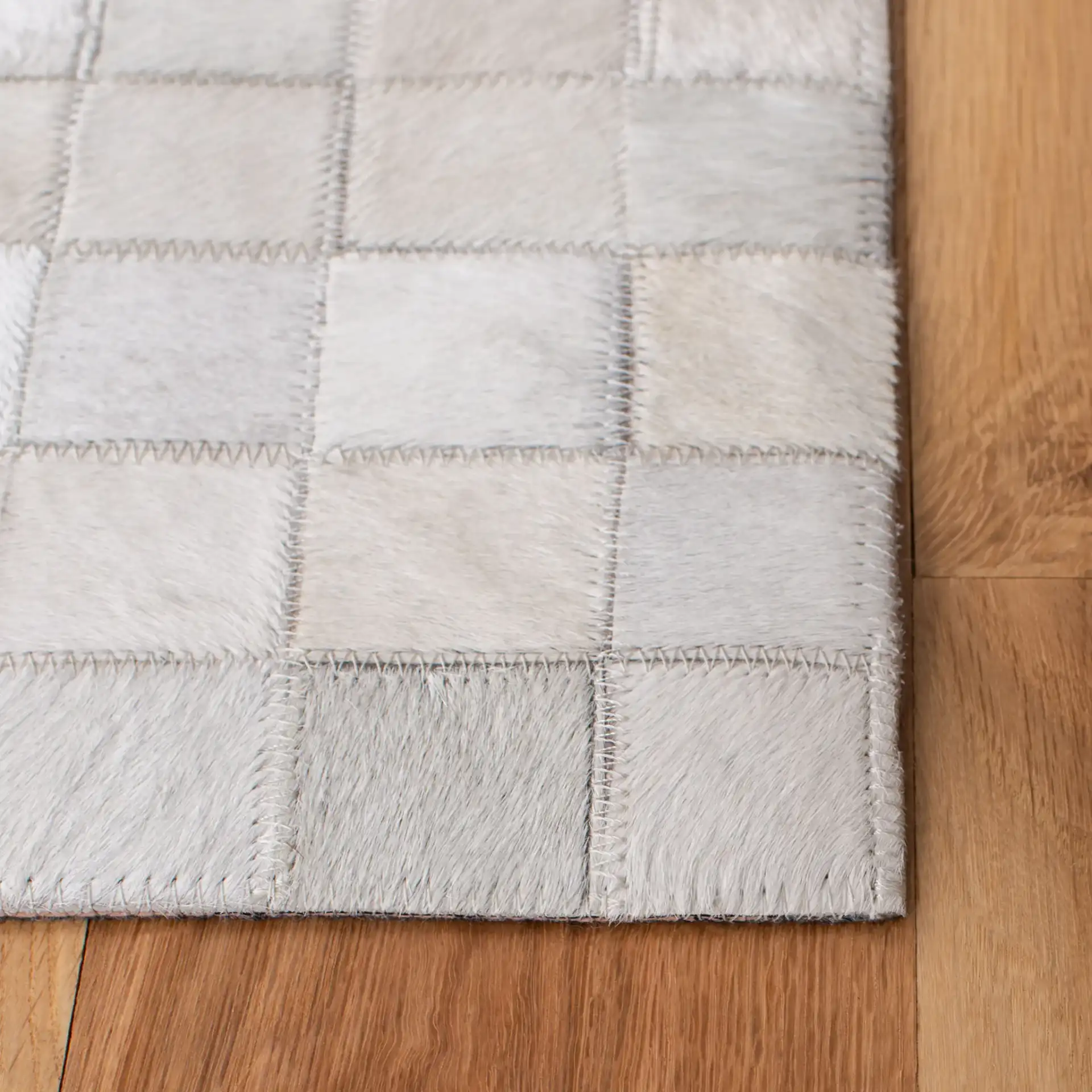 Studio Leather Gradient Grid Hand-Woven Rug in Ivory / Black in a styled room