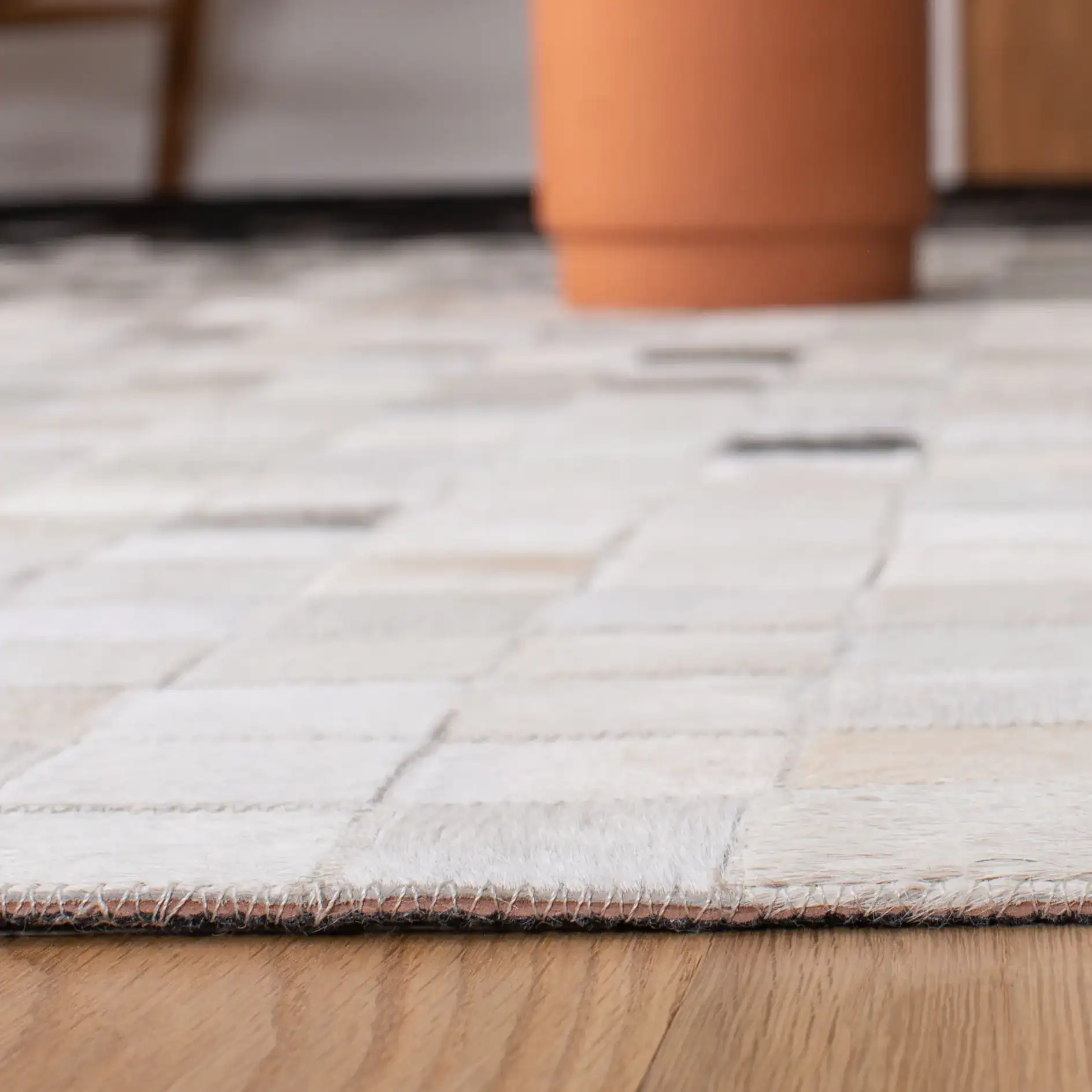Studio Leather Gradient Grid Hand-Woven Rug in Ivory / Black in a styled room