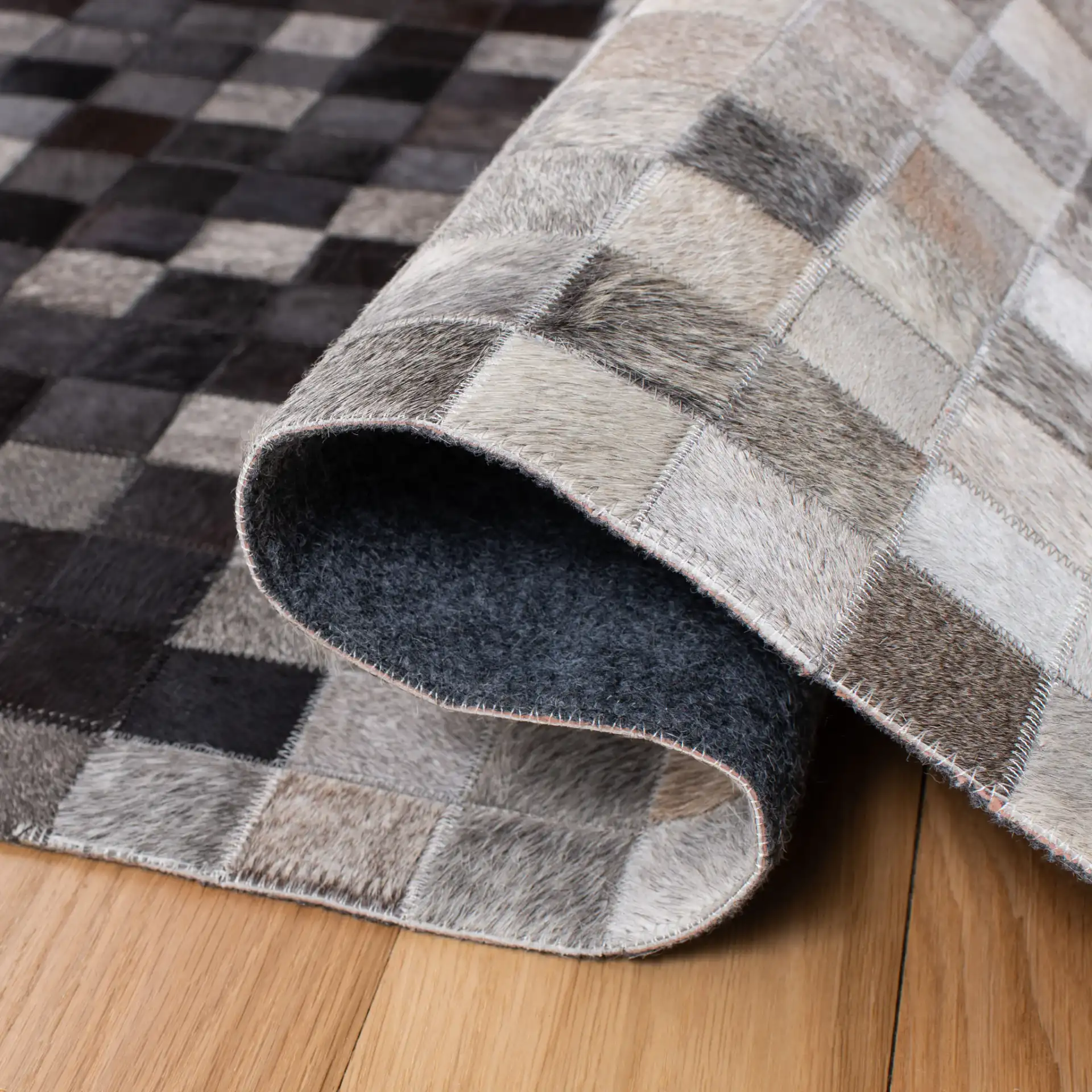 Studio Leather Gradient Grid Hand-Woven Rug in Ivory / Black in a styled room