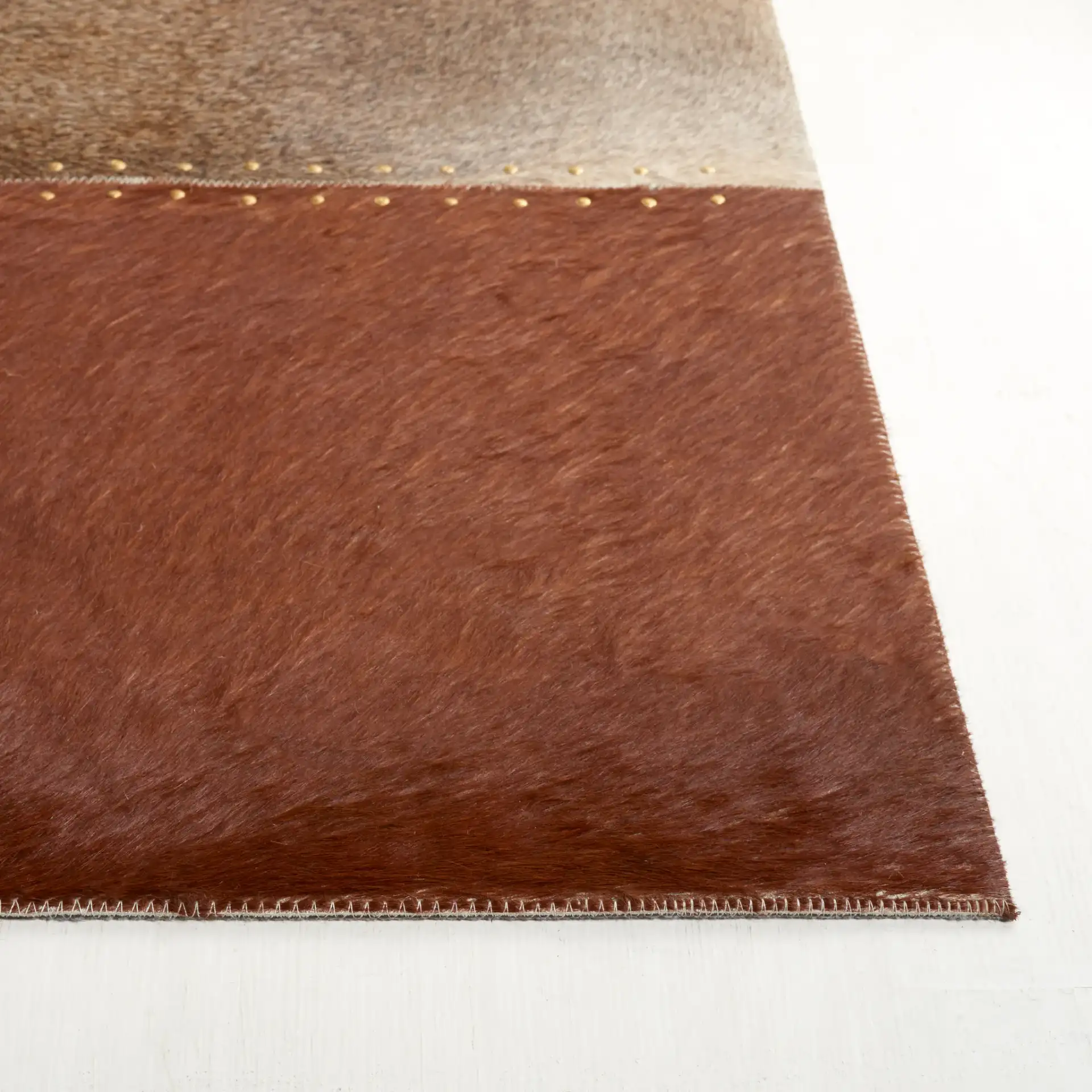 Studio Leather Rustic Block Patchwork Hand-Woven Rug in Brown / Ivory in a styled room