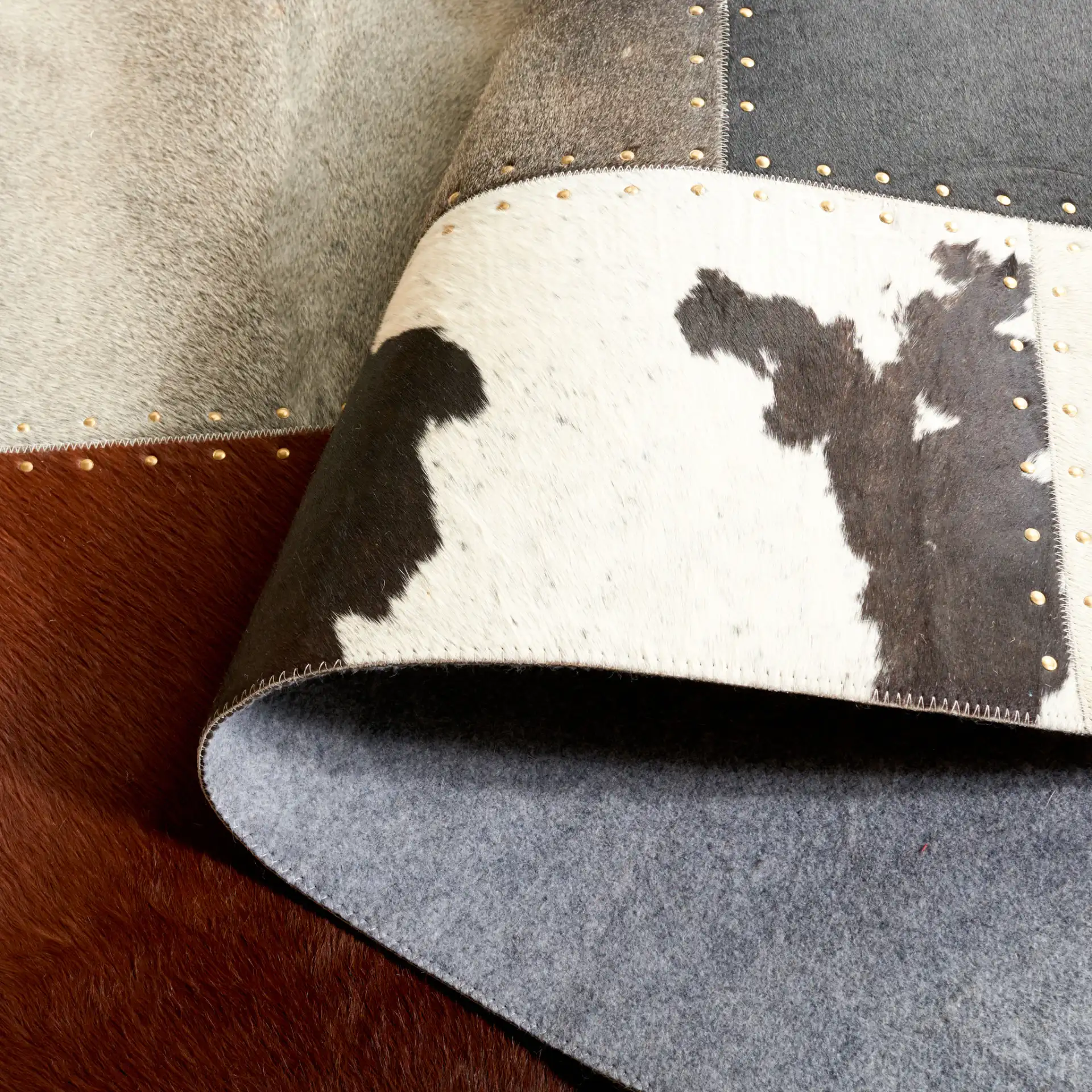 Studio Leather Rustic Block Patchwork Hand-Woven Rug in Brown / Ivory in a styled room