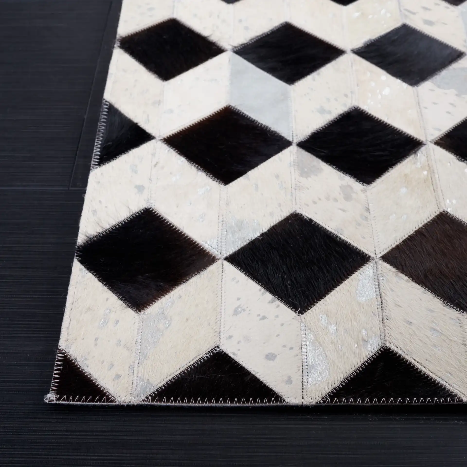Studio Leather Cube Patchwork Hand-Woven Rug in Beige / Black in a styled room