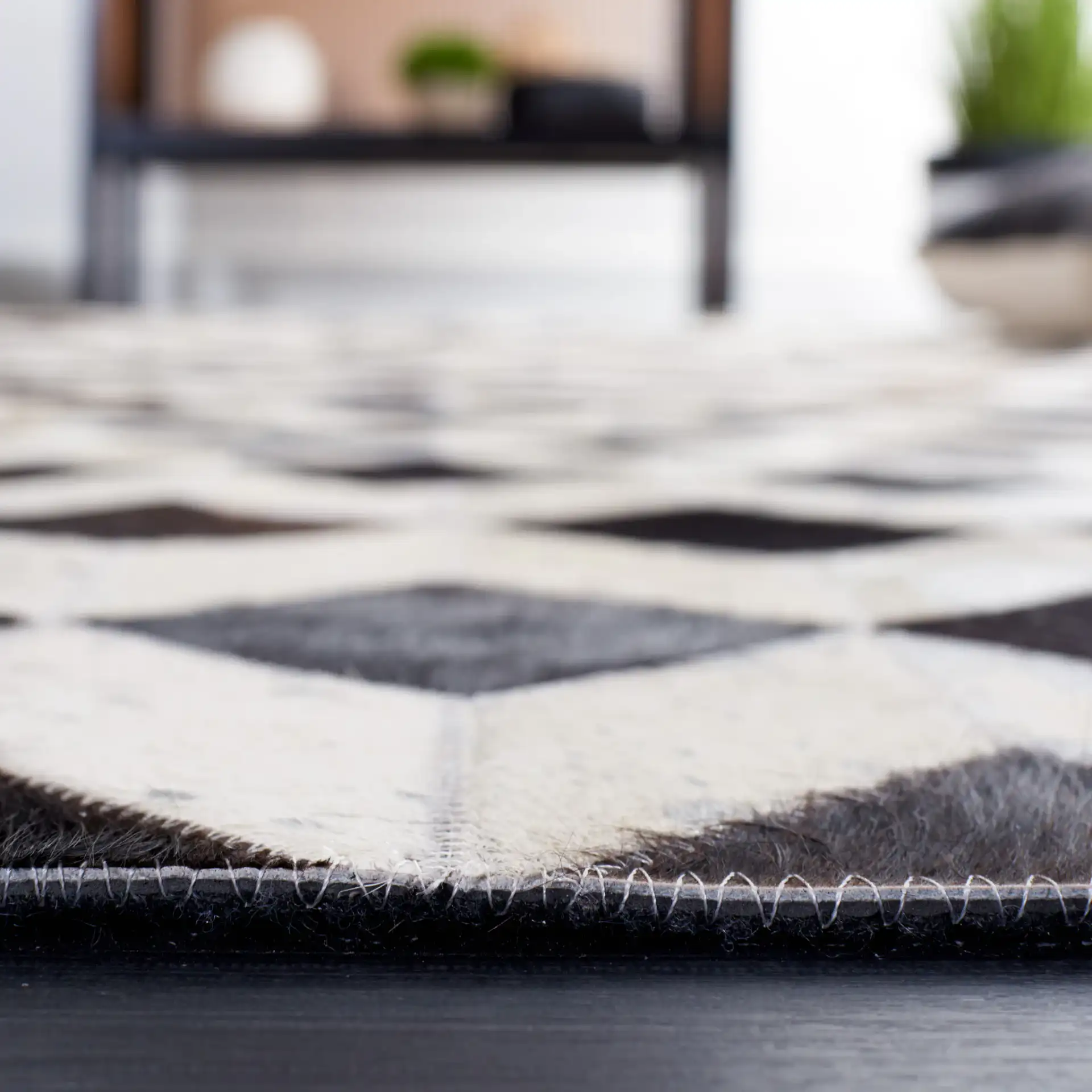 Studio Leather Cube Patchwork Hand-Woven Rug in Beige / Black in a styled room