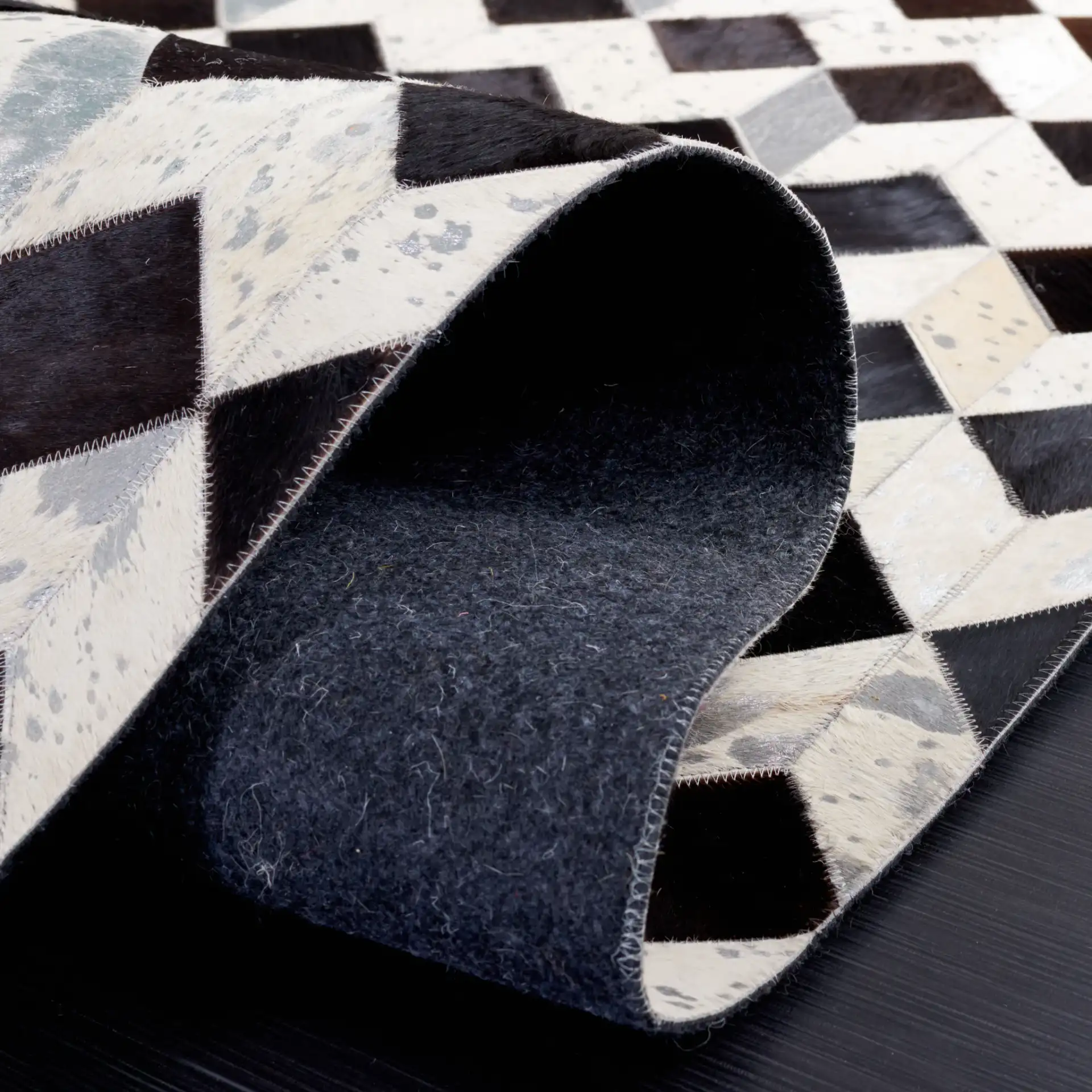 Studio Leather Cube Patchwork Hand-Woven Rug in Beige / Black in a styled room