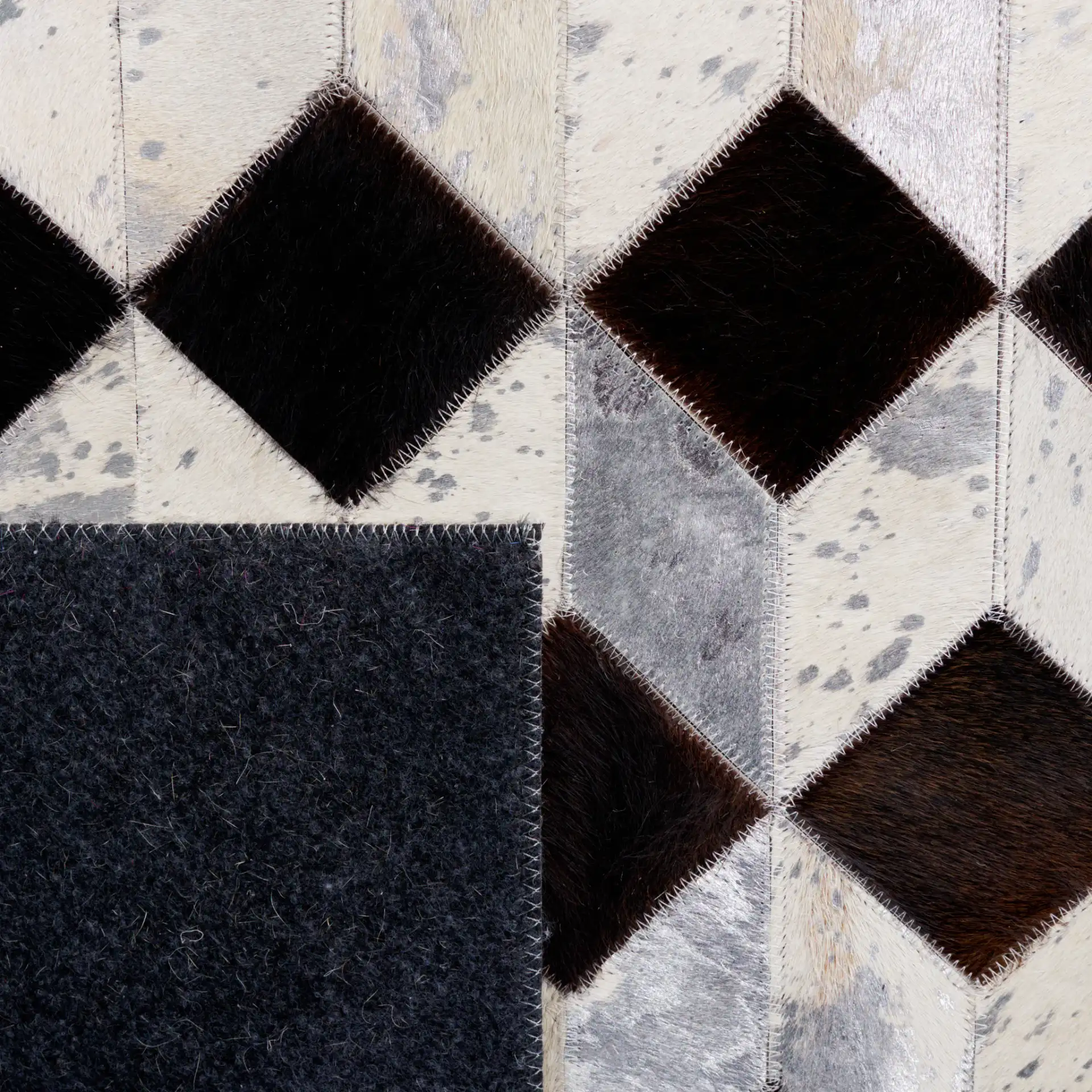 Studio Leather Cube Patchwork Hand-Woven Rug in Beige / Black in a styled room