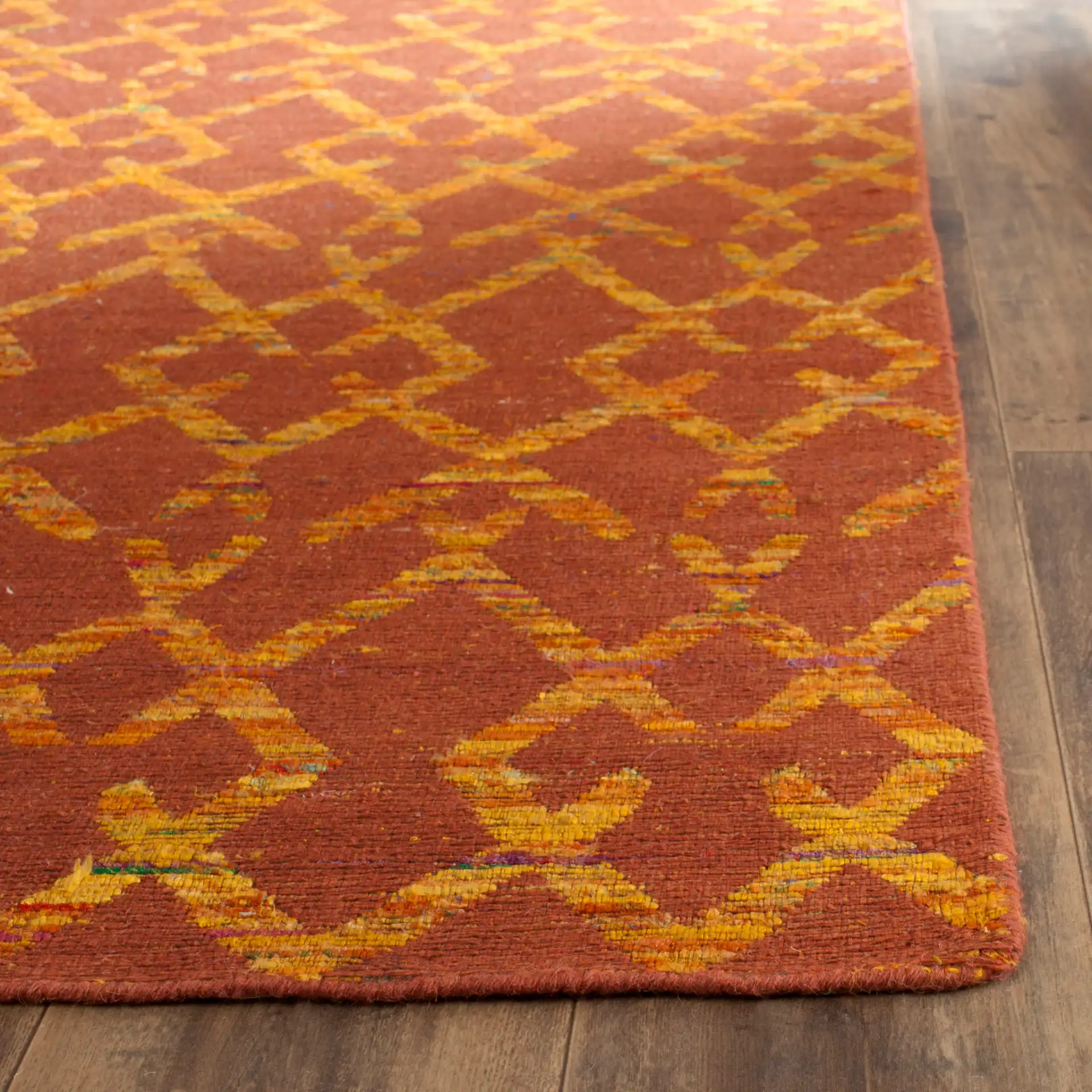 Straw Patch Interlocking Diamond Hand-Woven Rug in Rust / Gold in a styled room