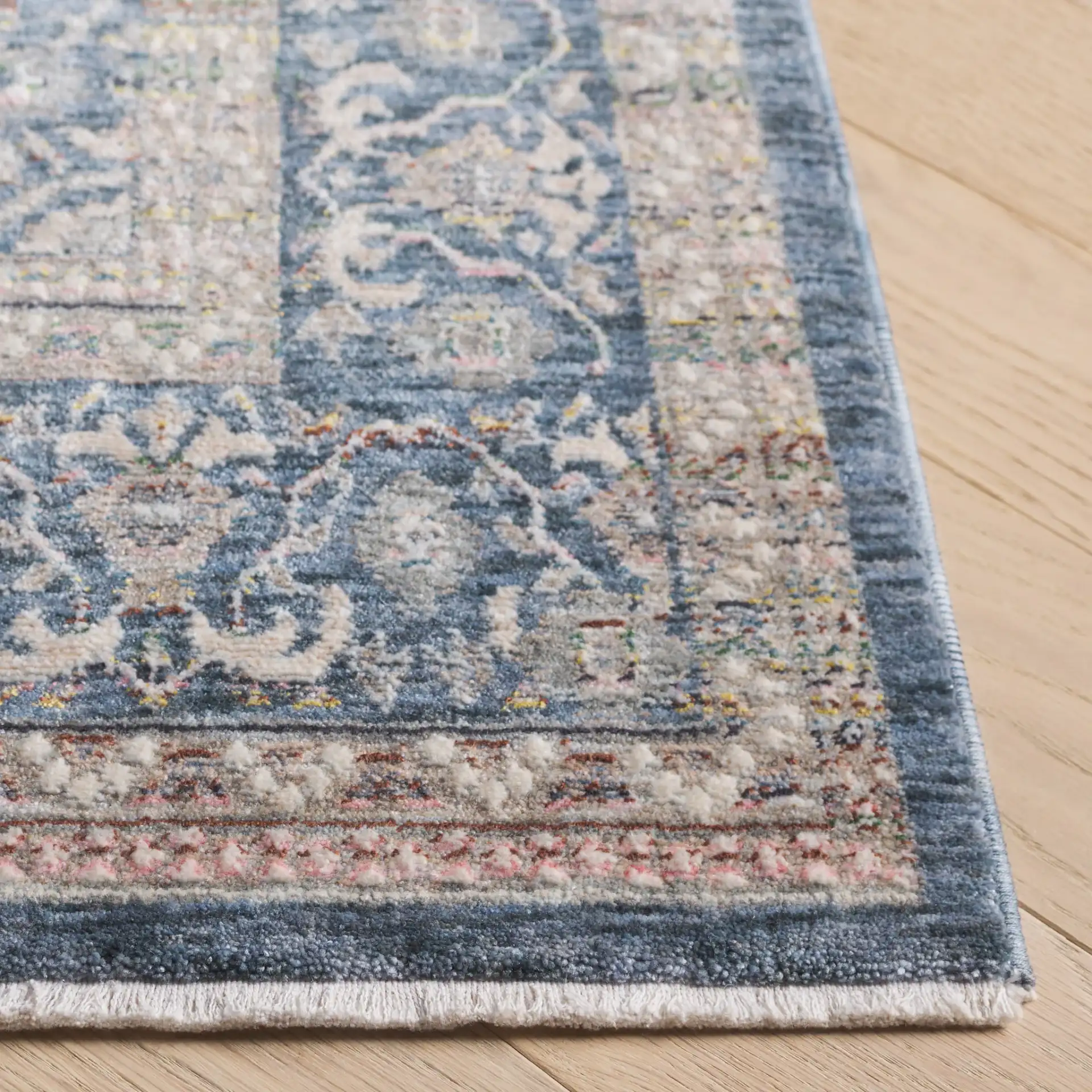Sutton Bordered Floral Rug in Navy / Beige in a styled room