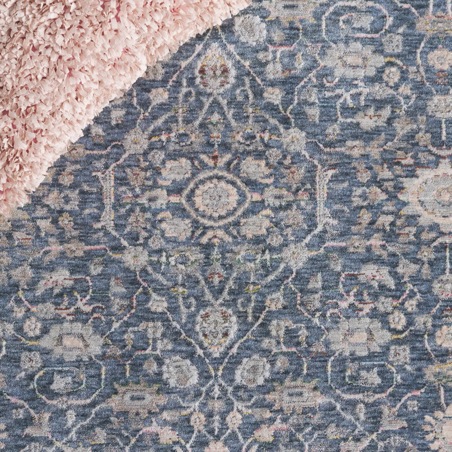 Sutton Bordered Floral Rug in Navy / Beige in a styled room