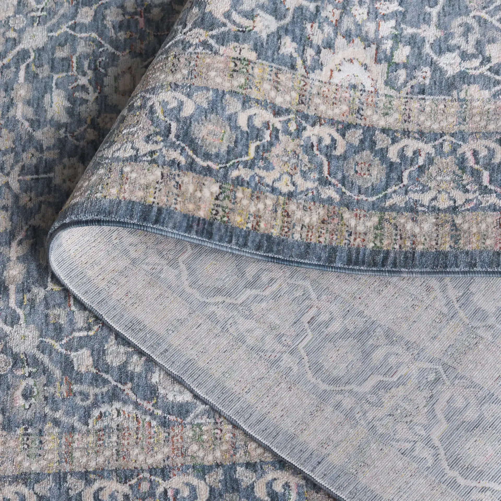 Sutton Bordered Floral Rug in Navy / Beige in a styled room