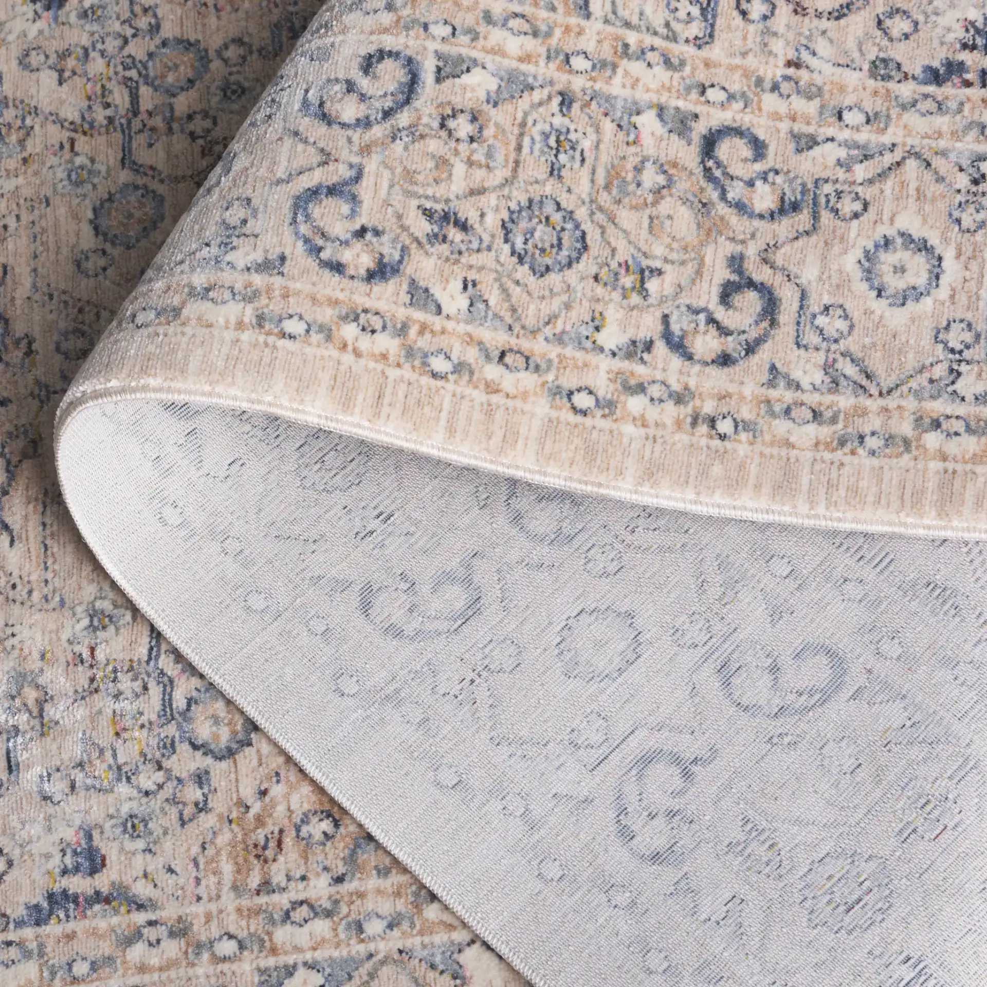 Sutton Floral Bordered Rug in Beige / Navy in a styled room