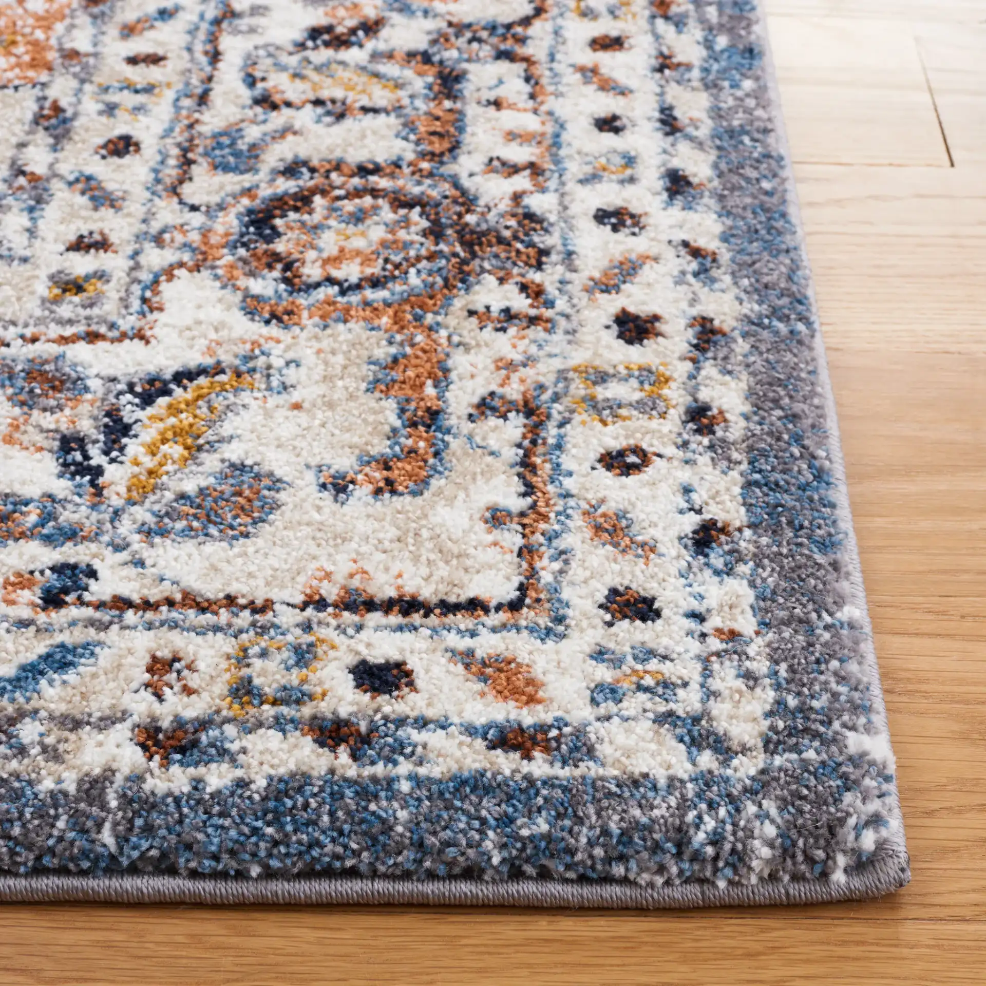 Symphony Medallion Bordered Rug in Ivory / Gray in a styled room