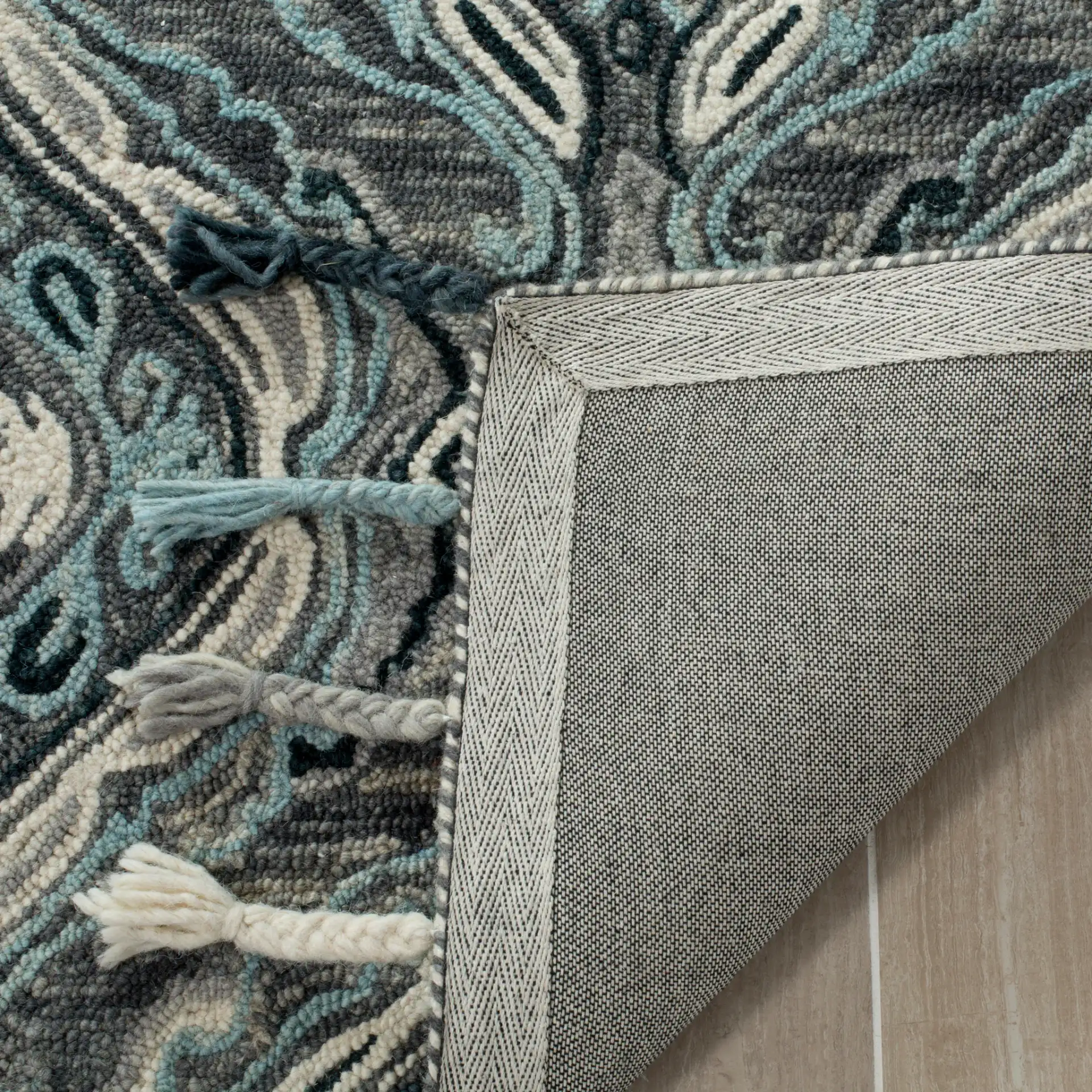 Suzani Ogee Hand-Hooked Wool Rug in Gray / Light Blue in a styled room