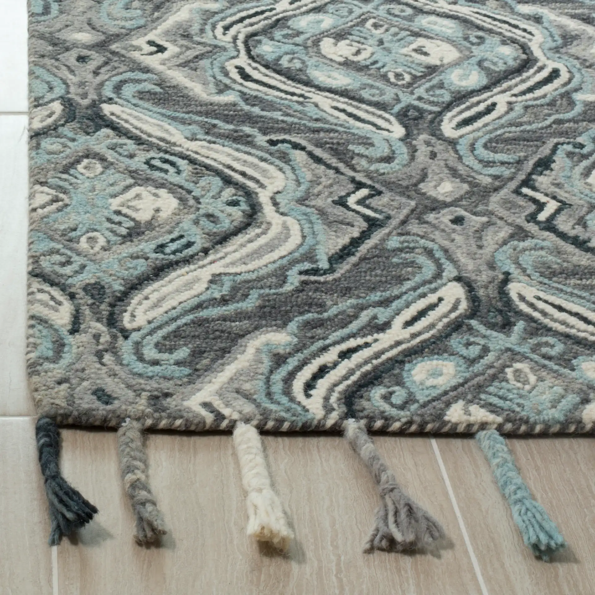 Suzani Ogee Hand-Hooked Wool Rug in Gray / Light Blue in a styled room
