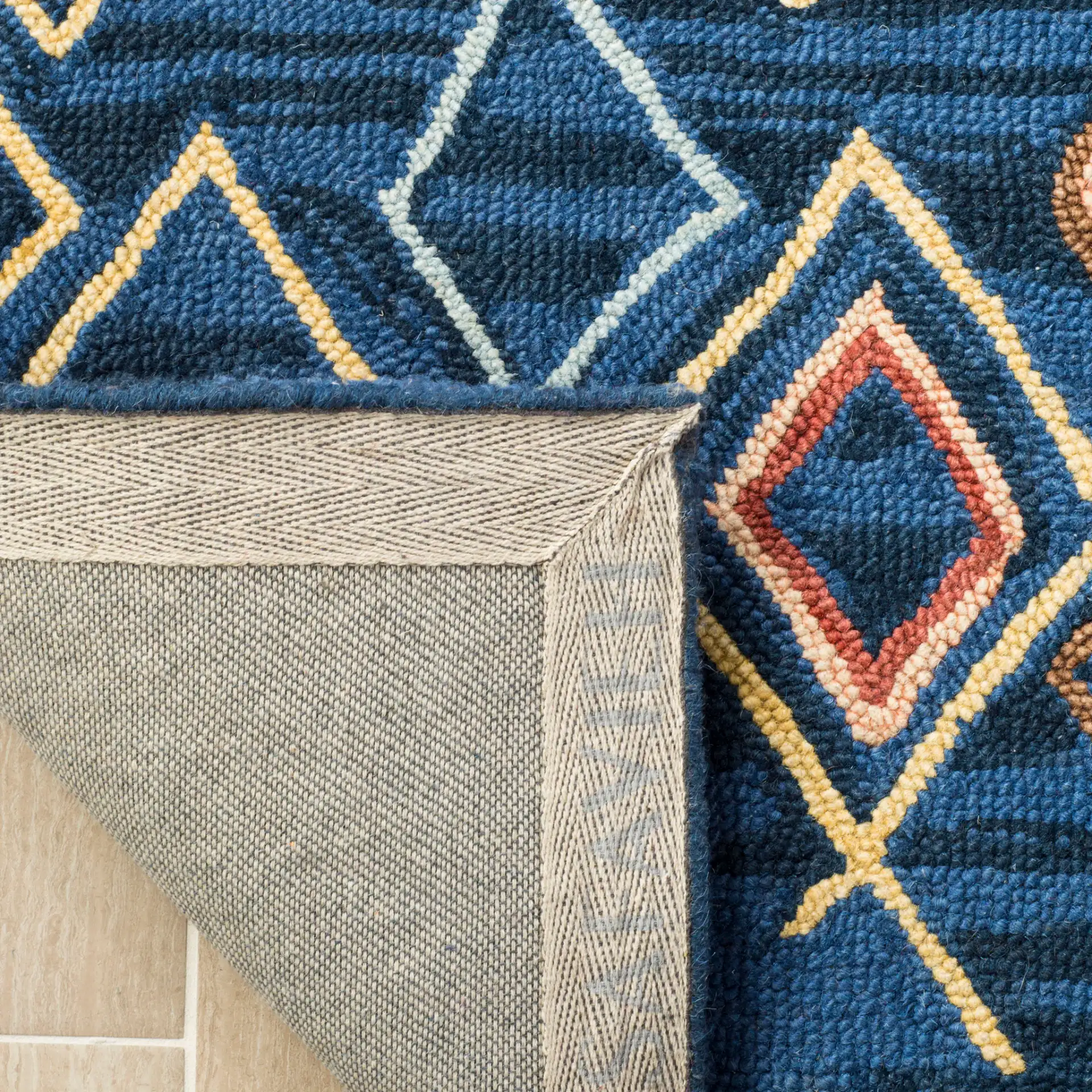 Suzani Diamond Hand-Hooked Wool Rug in Blue / Multicolor in a styled room