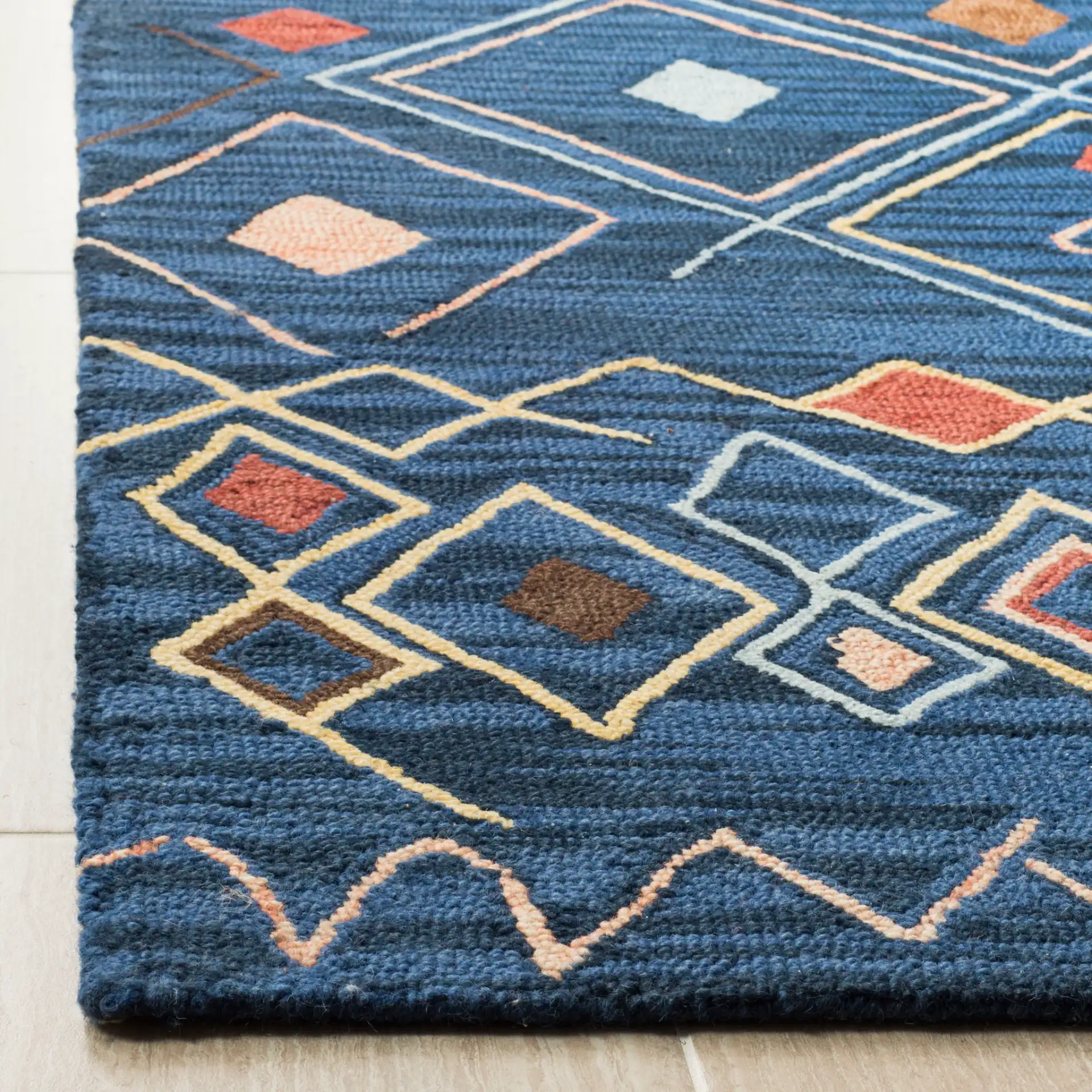 Suzani Diamond Hand-Hooked Wool Rug in Blue / Multicolor in a styled room