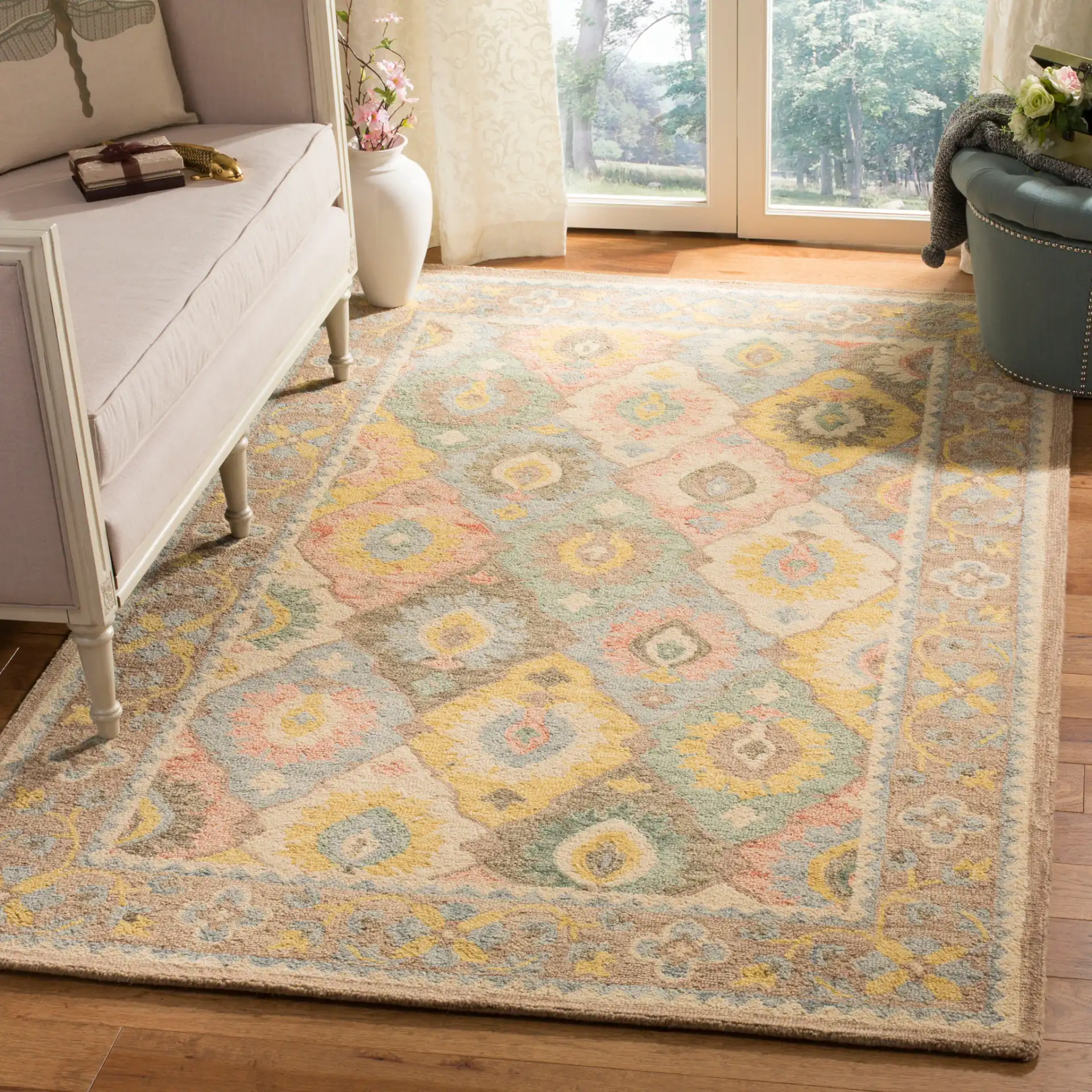 Suzani Bordered Ikat Diamond Hand-Hooked Wool Rug in Ivory / Multicolor in a styled room