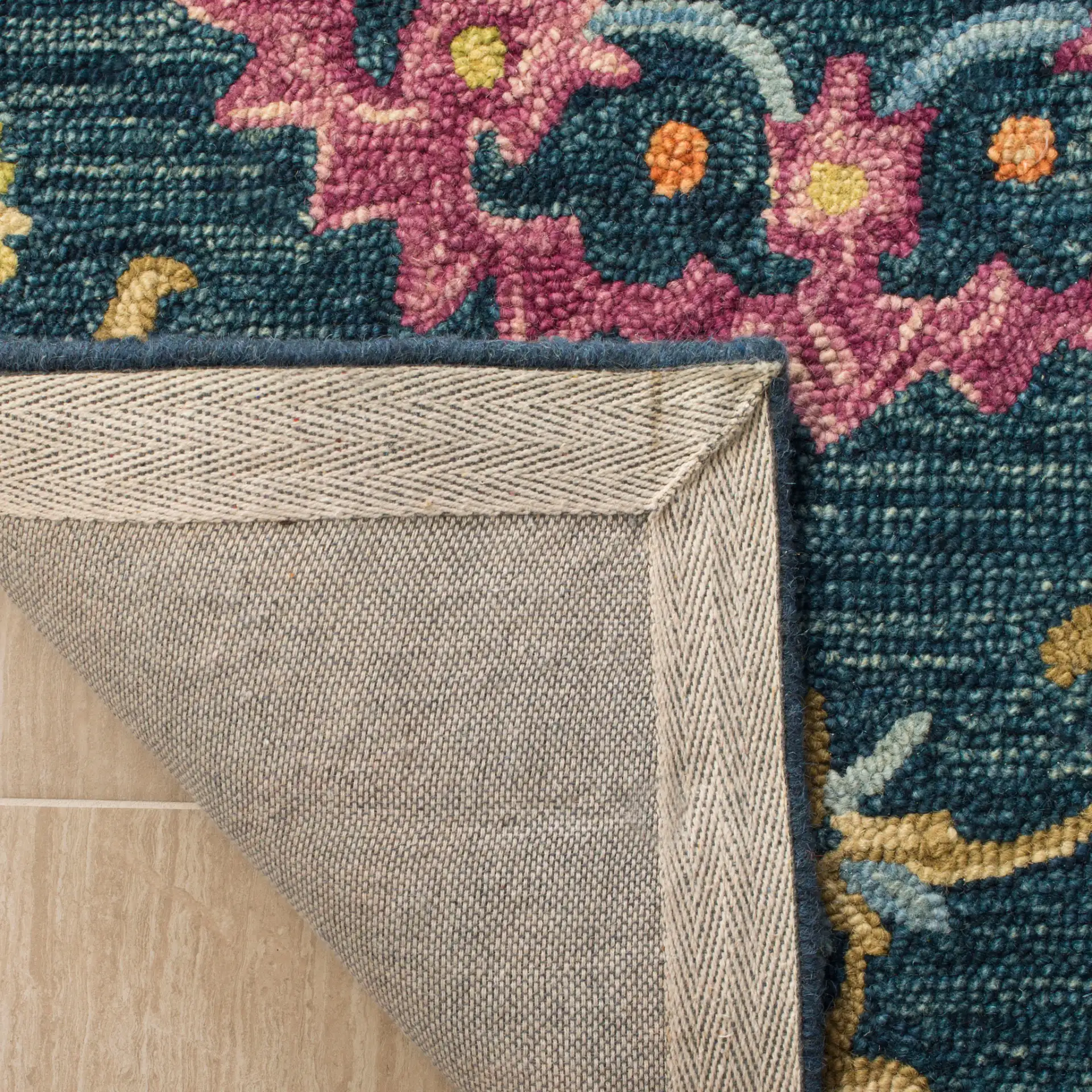 Suzani Rosette Trellis Hand-Hooked Wool Rug in Blue / Multicolor in a styled room