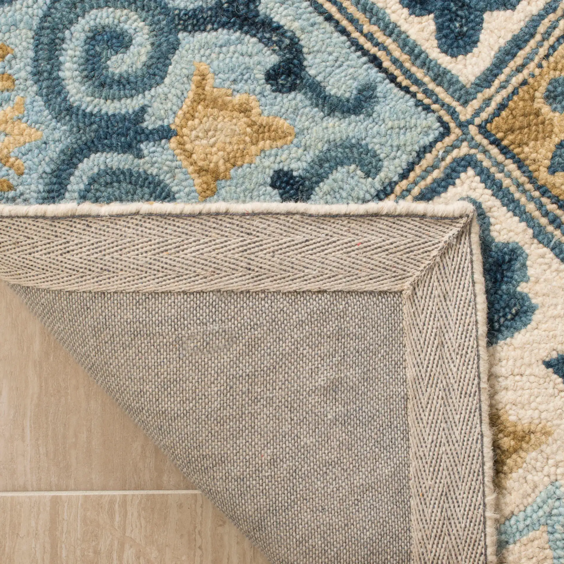 Suzani Floral Tile Hand-Hooked Wool Rug in Ivory / Blue in a styled room