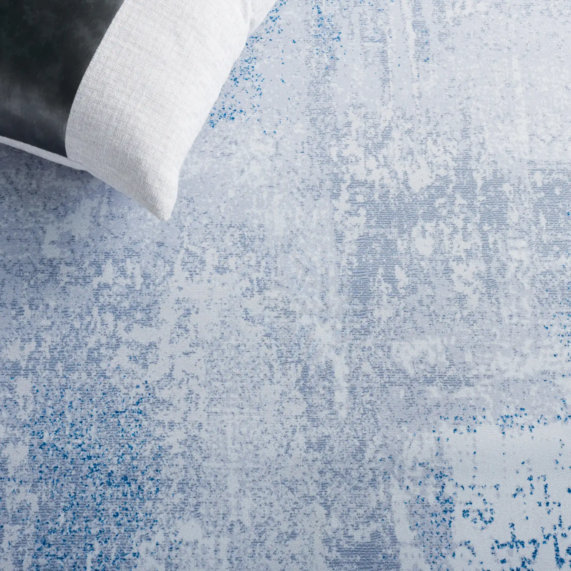 Tacoma Abstract Patchwork Washable Rug in Gray / Blue in a styled room