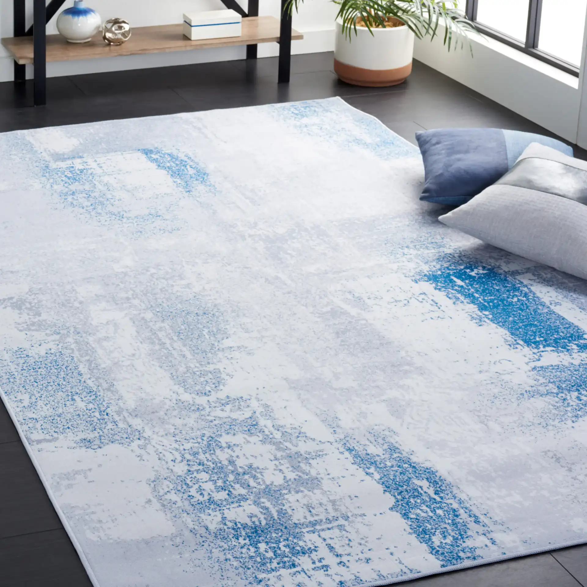 Tacoma Abstract Patchwork Washable Rug in Gray / Blue in a styled room