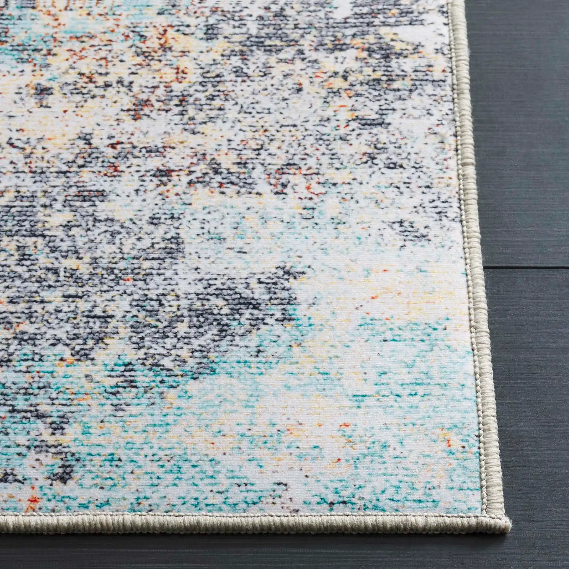 Tacoma Abstract Washable Rug in Rust / Aqua in a styled room