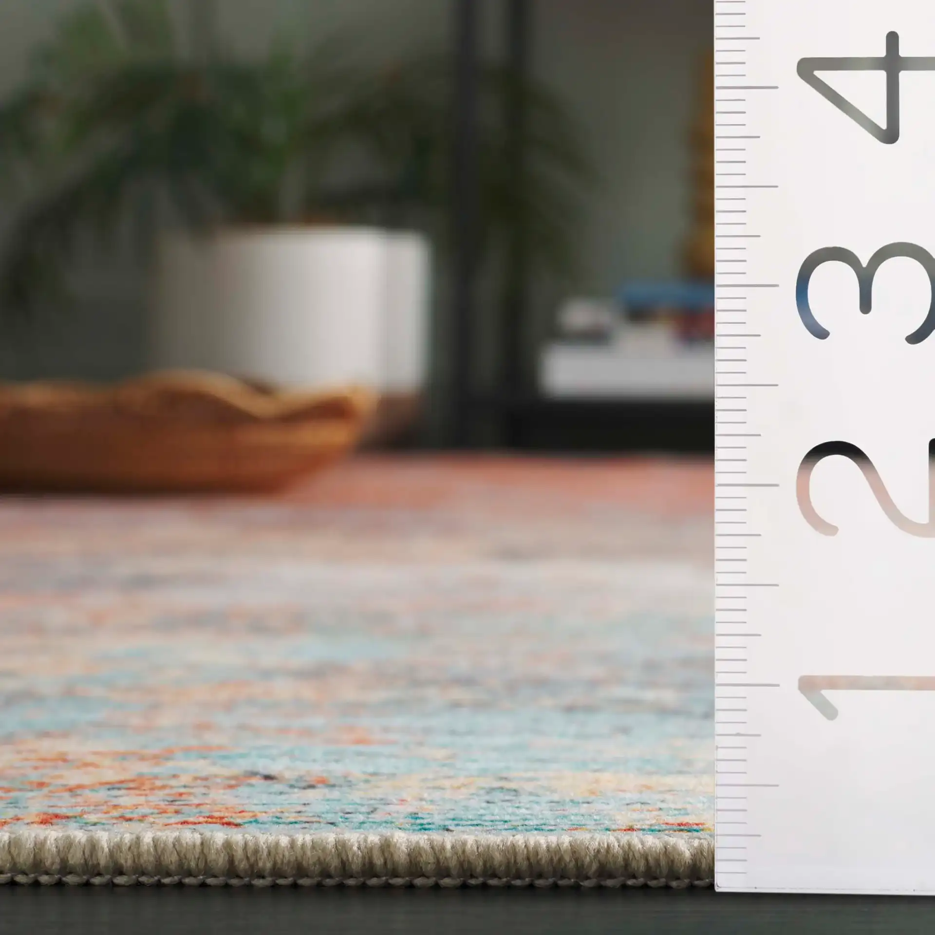 Tacoma Abstract Washable Rug in Rust / Aqua in a styled room