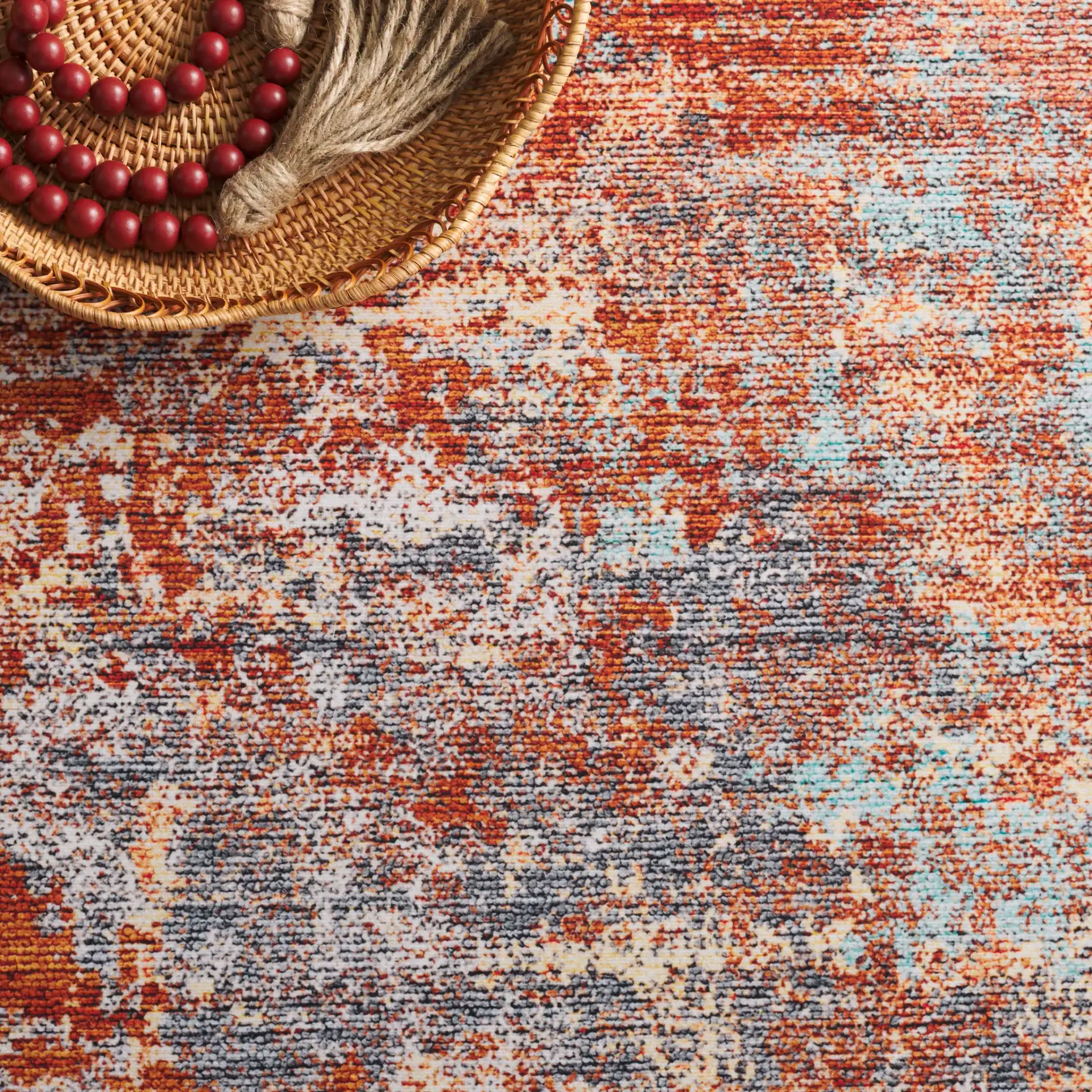 Tacoma Abstract Washable Rug in Rust / Aqua in a styled room