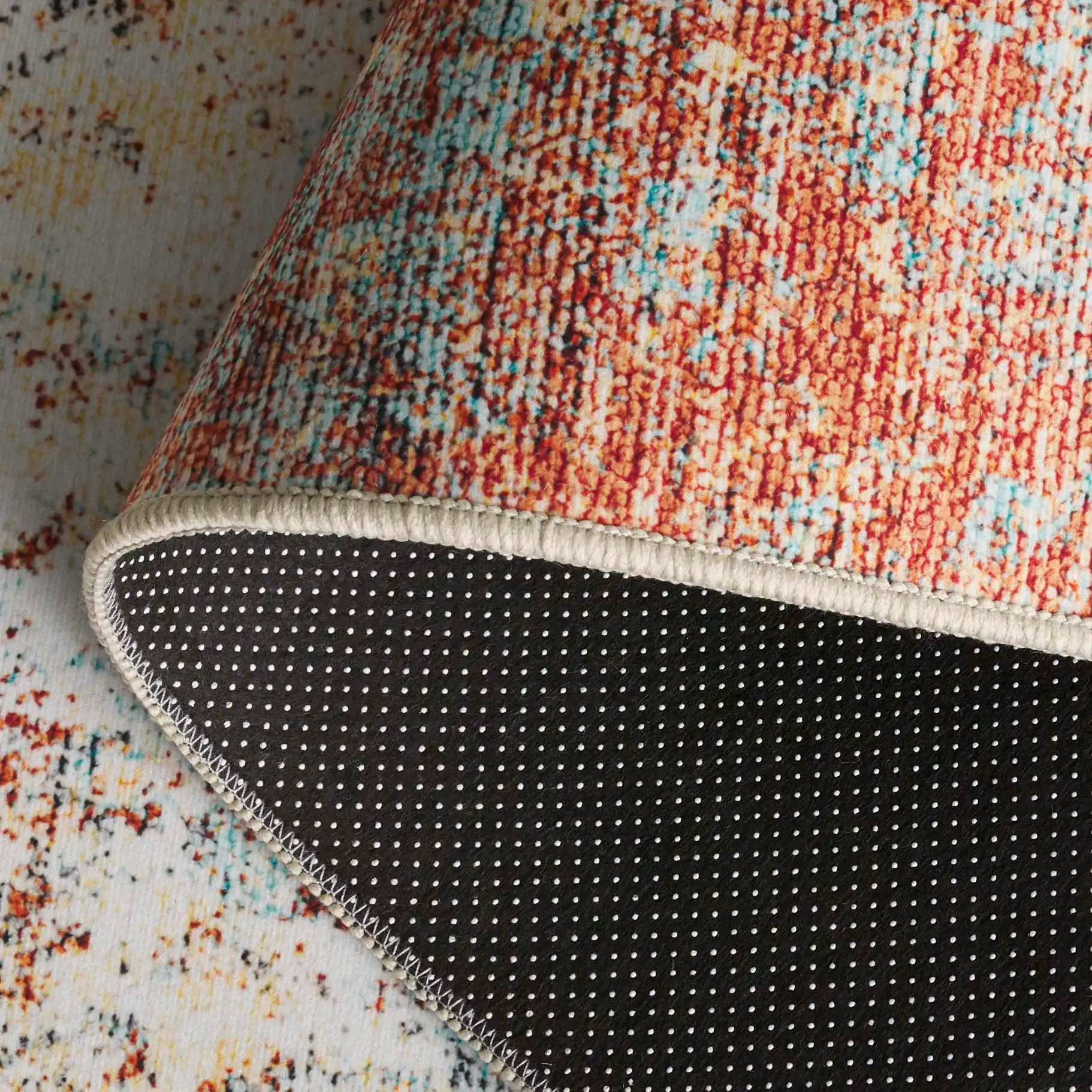 Tacoma Abstract Washable Rug in Rust / Aqua in a styled room