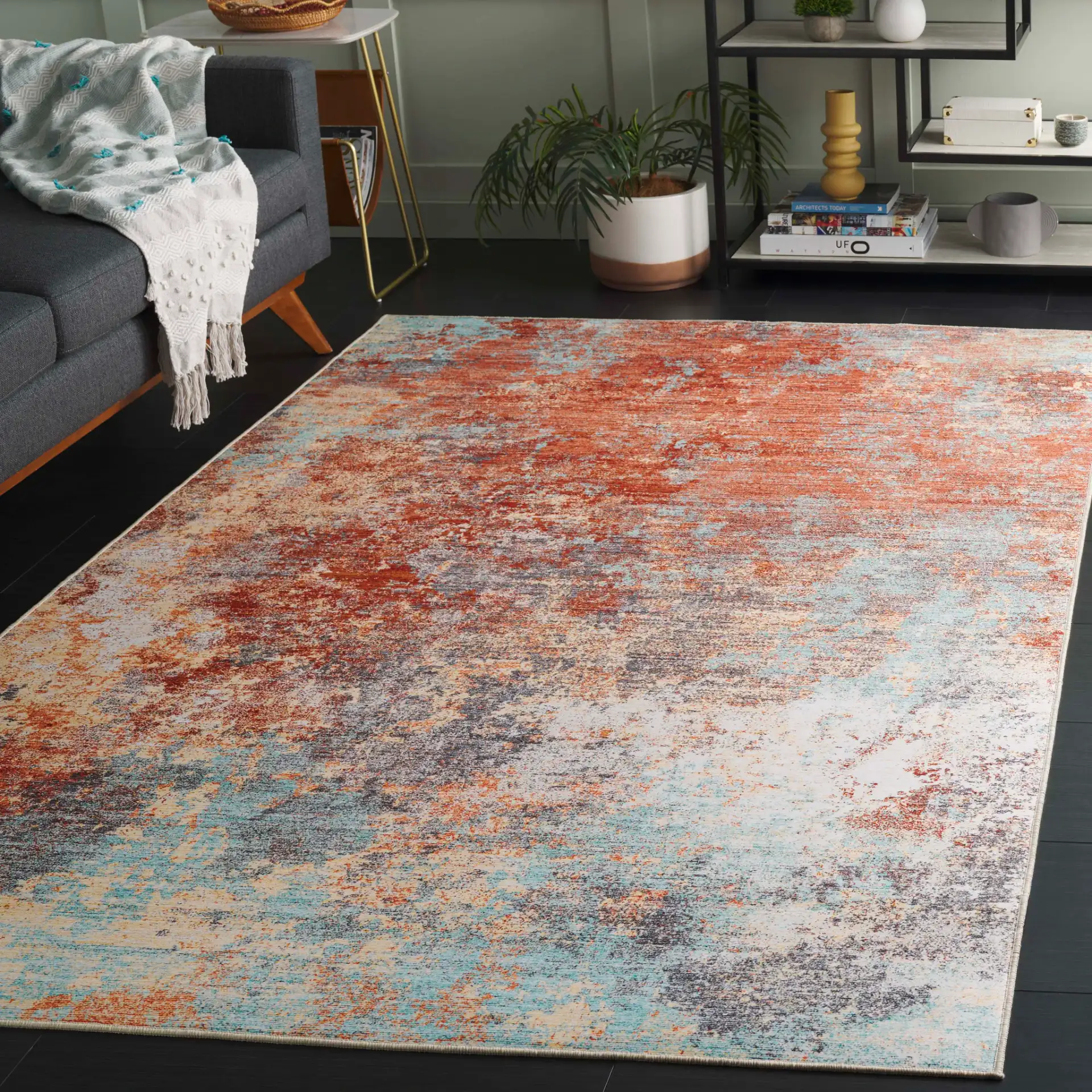 Tacoma Abstract Washable Rug in Rust / Aqua in a styled room