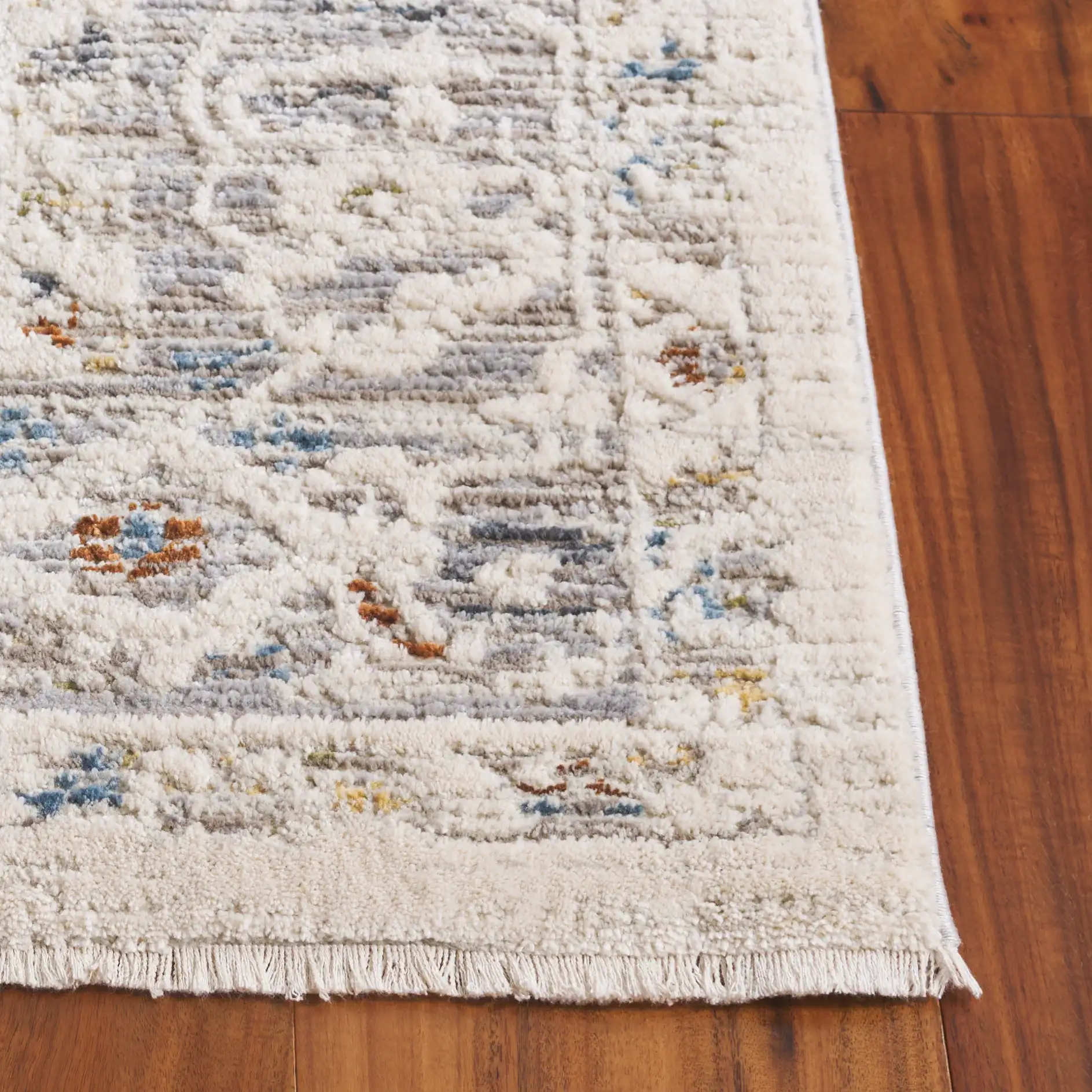 Taylor Distressed Bordered Rug in Ivory / Gray in a styled room
