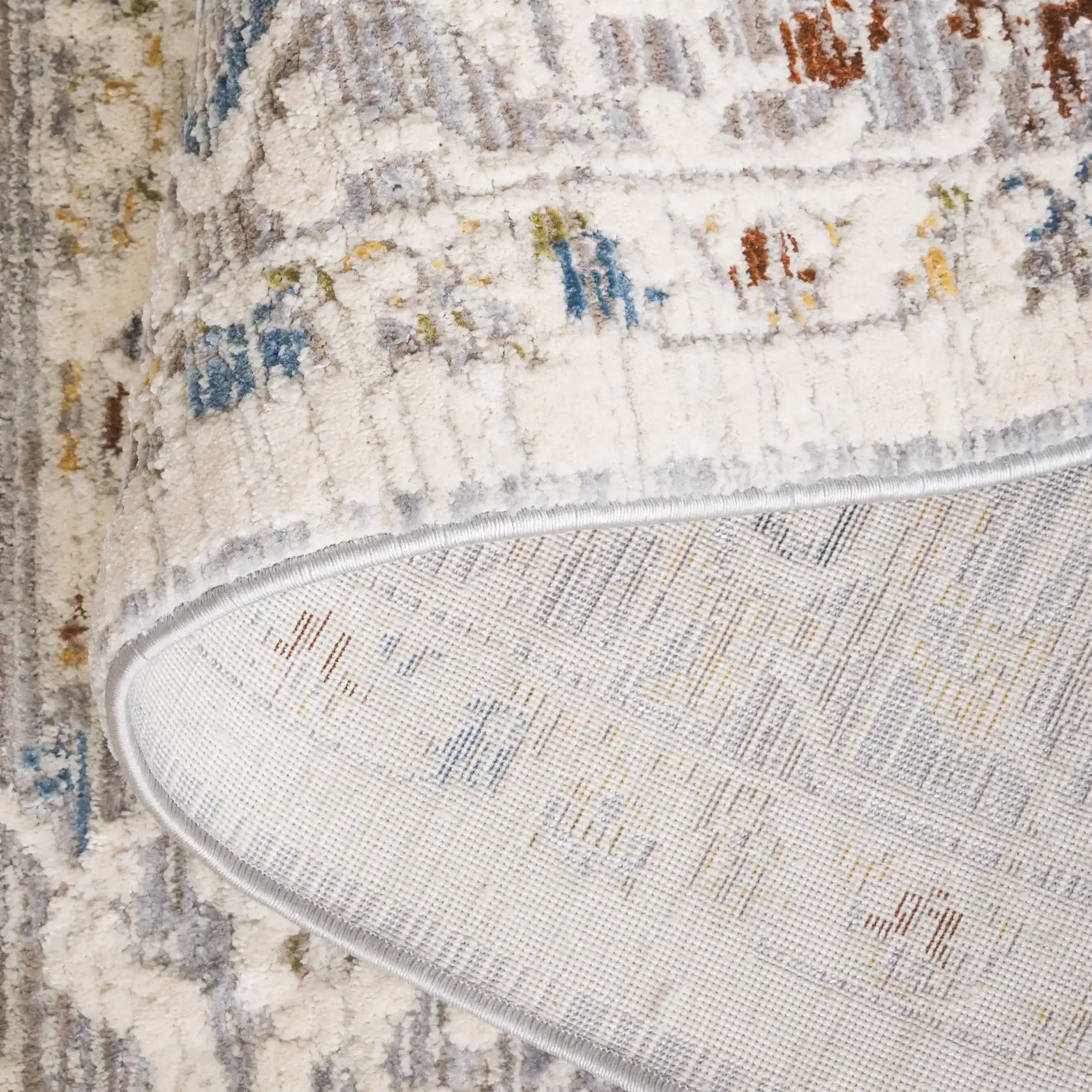 Taylor Distressed Bordered Rug in Ivory / Gray in a styled room