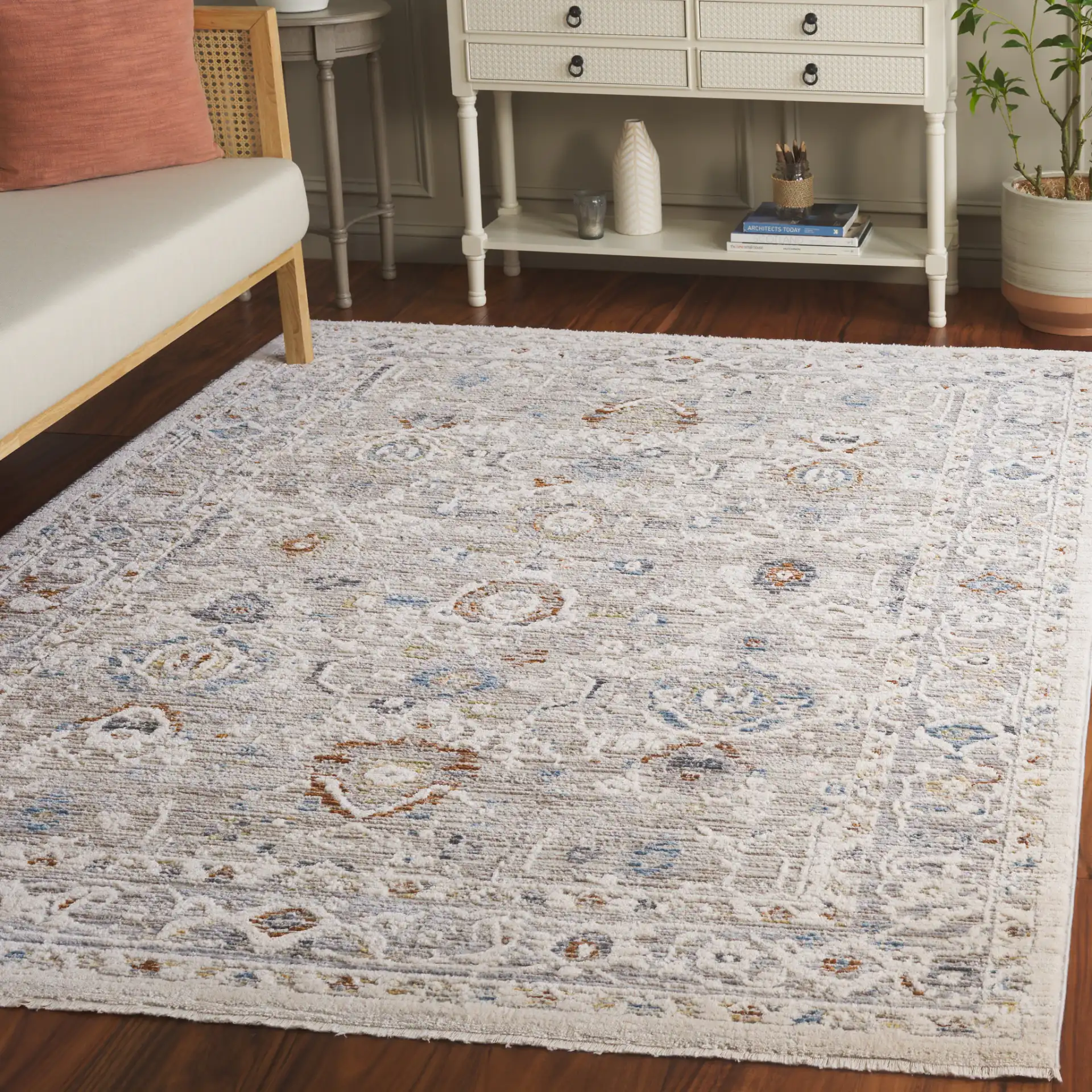 Taylor Distressed Bordered Rug in Ivory / Gray in a styled room