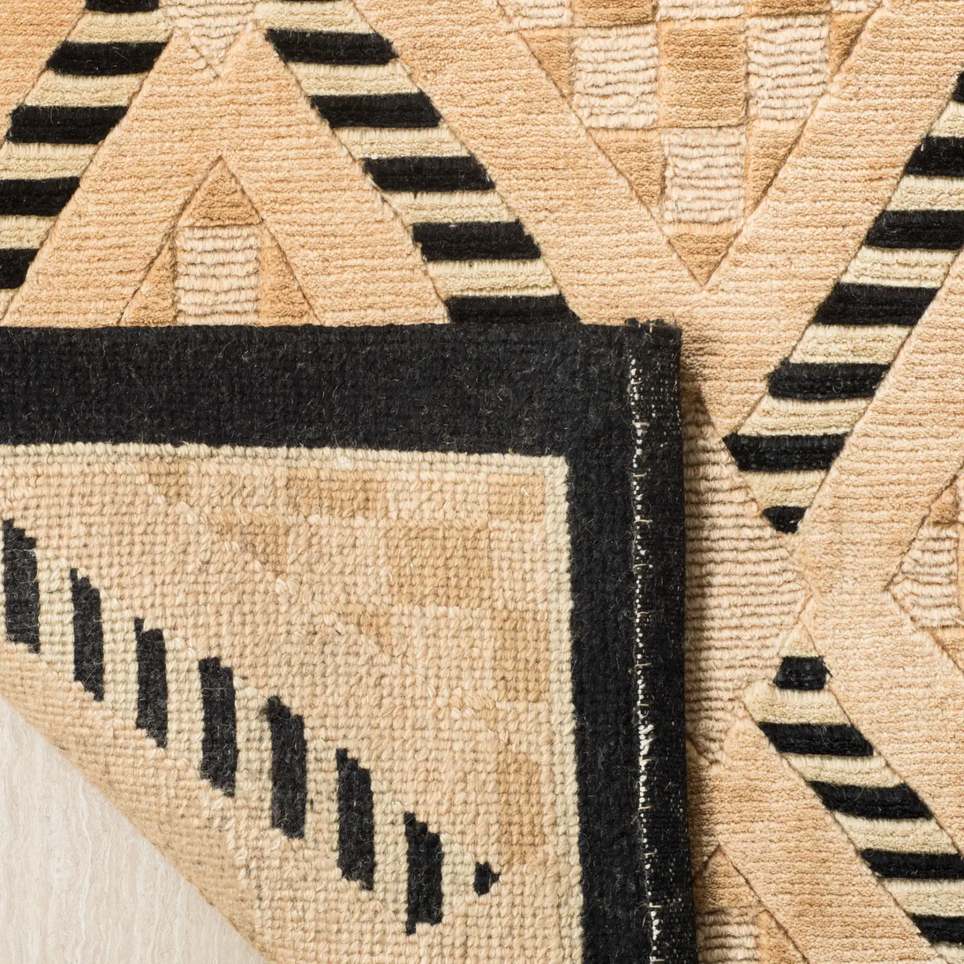 Tibetan Textured Diamond Hand-Knotted Wool Rug in Black / Gold in a styled room