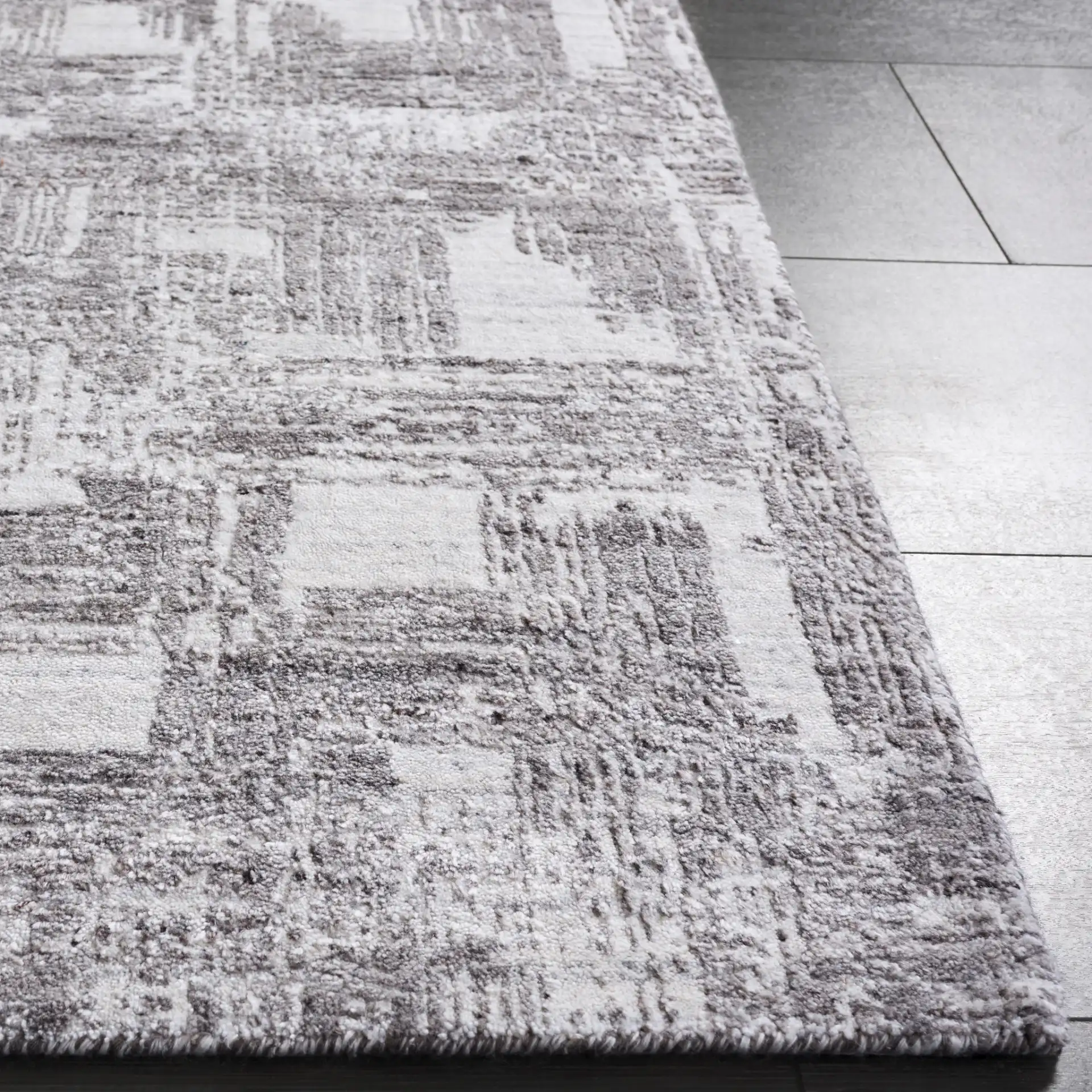 Tibetan Textured Grid Hand-Loomed Rug in Ivory / Gray in a styled room