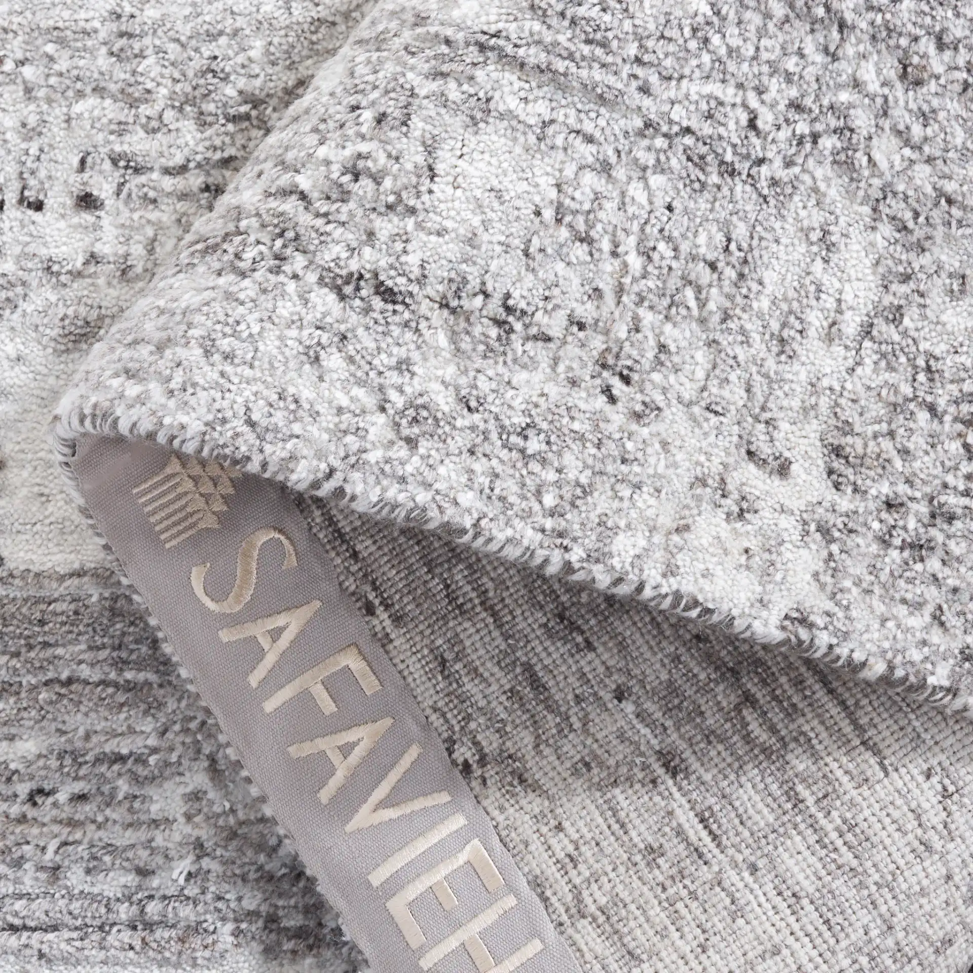 Tibetan Textured Grid Hand-Loomed Rug in Ivory / Gray in a styled room
