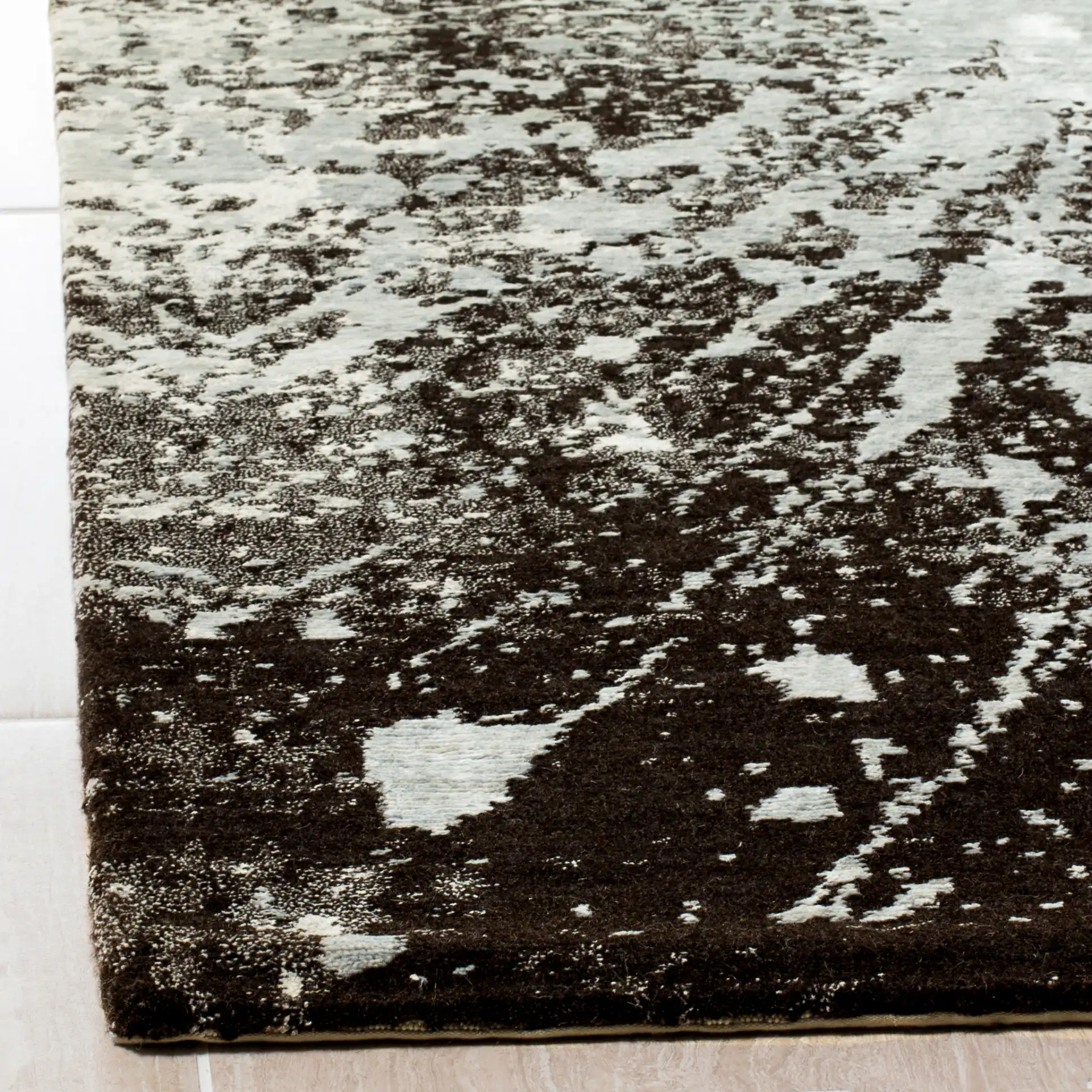 Tibetan Starburst Hand-Knotted Rug in Silver / Black in a styled room