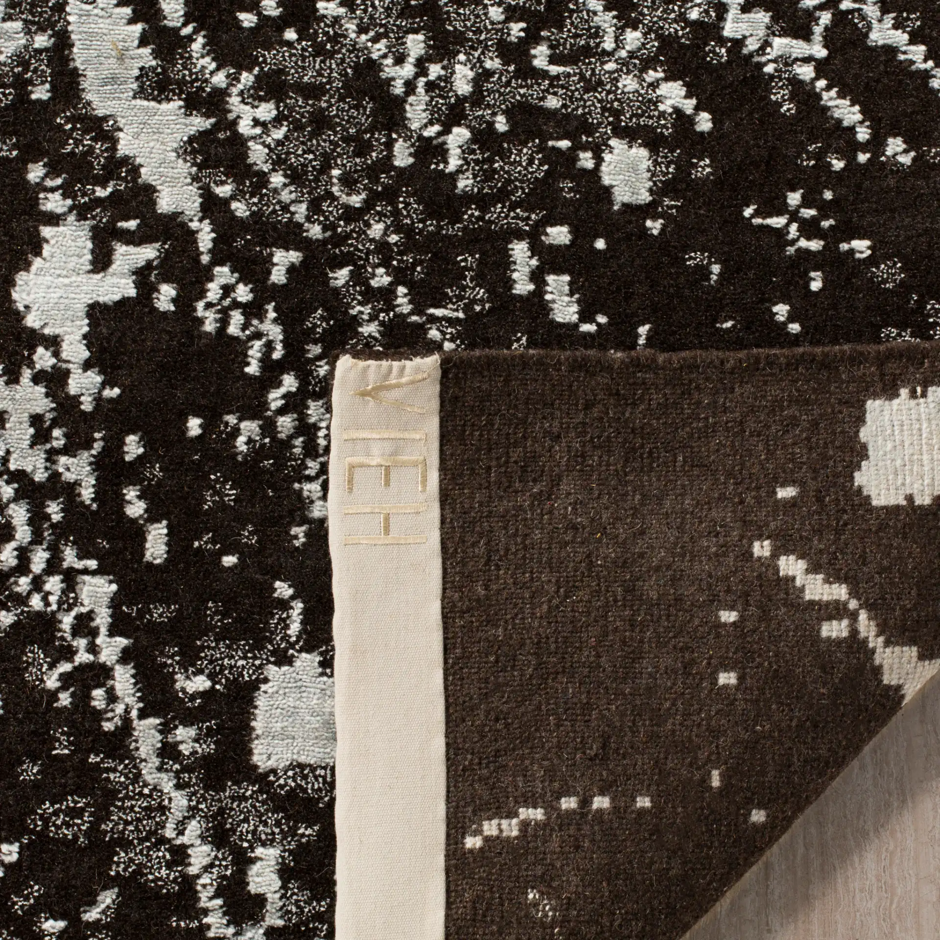 Tibetan Starburst Hand-Knotted Rug in Silver / Black in a styled room