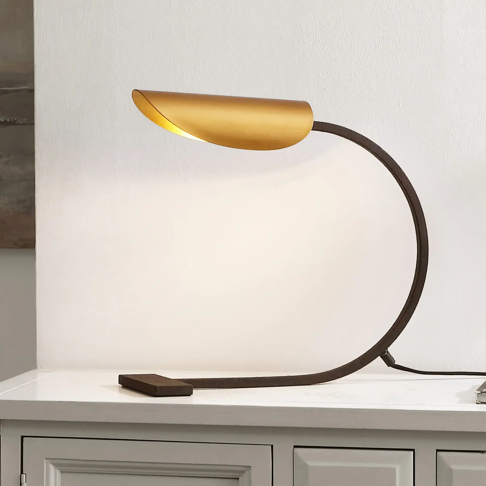 Mari Table Lamp in Antique Gold / Rust in a styled room