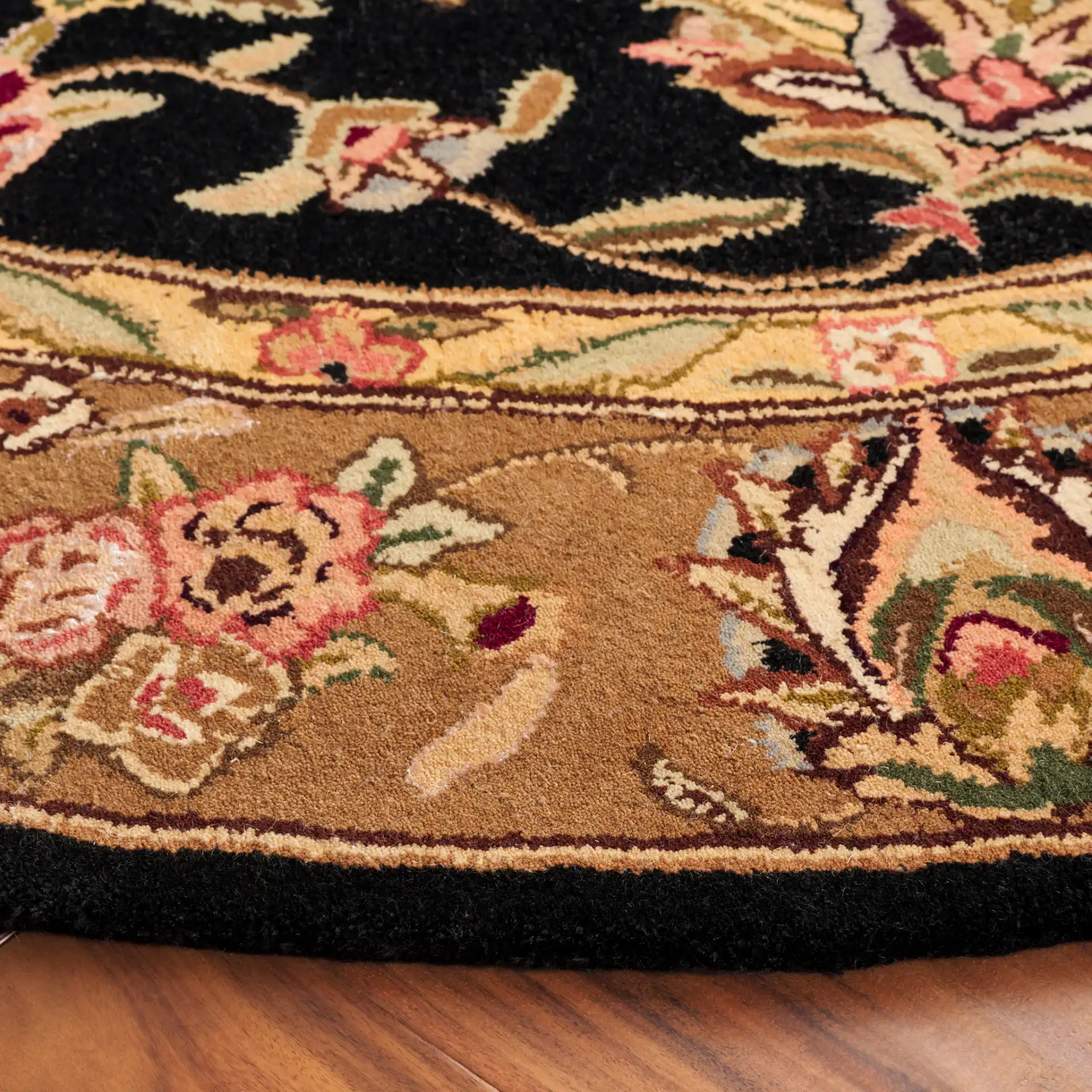 Traditions Floral Medallion Wool Rug in Black / Gold in a styled room
