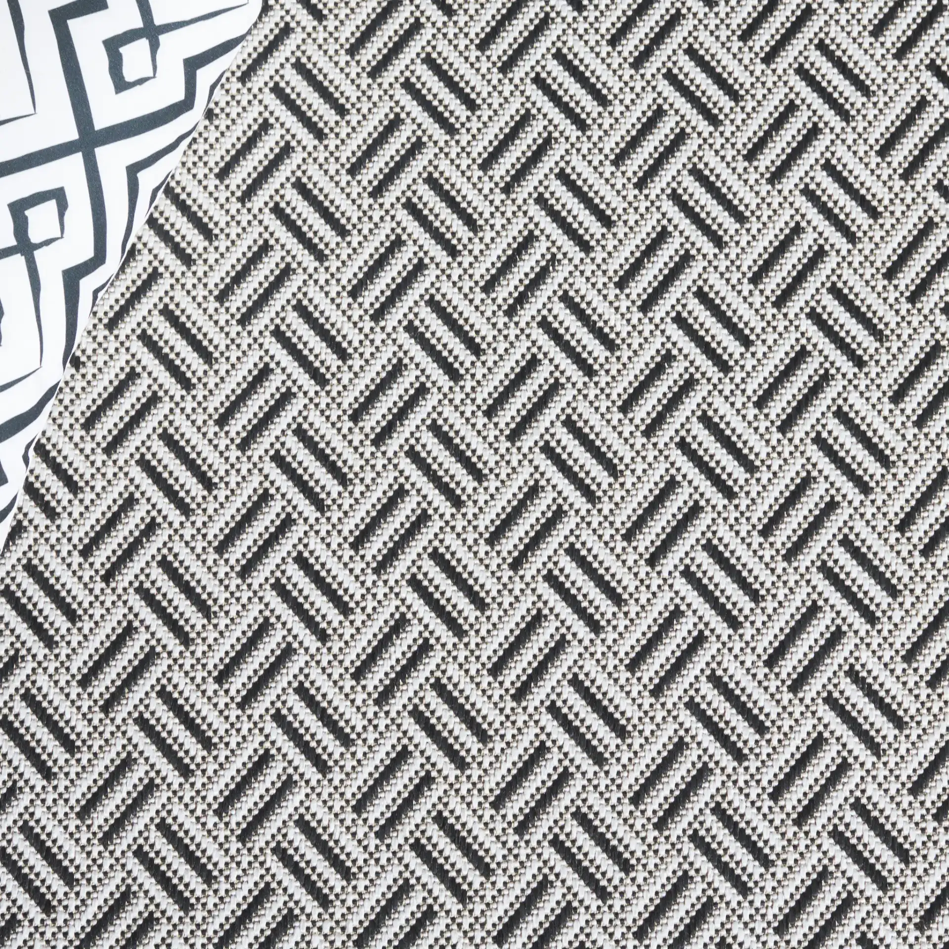 Terrace Basketweave Border Outdoor Rug in Black / White in a styled room