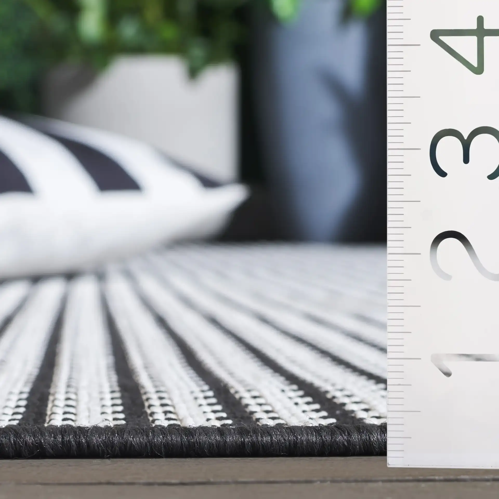 Terrace Basketweave Outdoor Rug in Black / White in a styled room