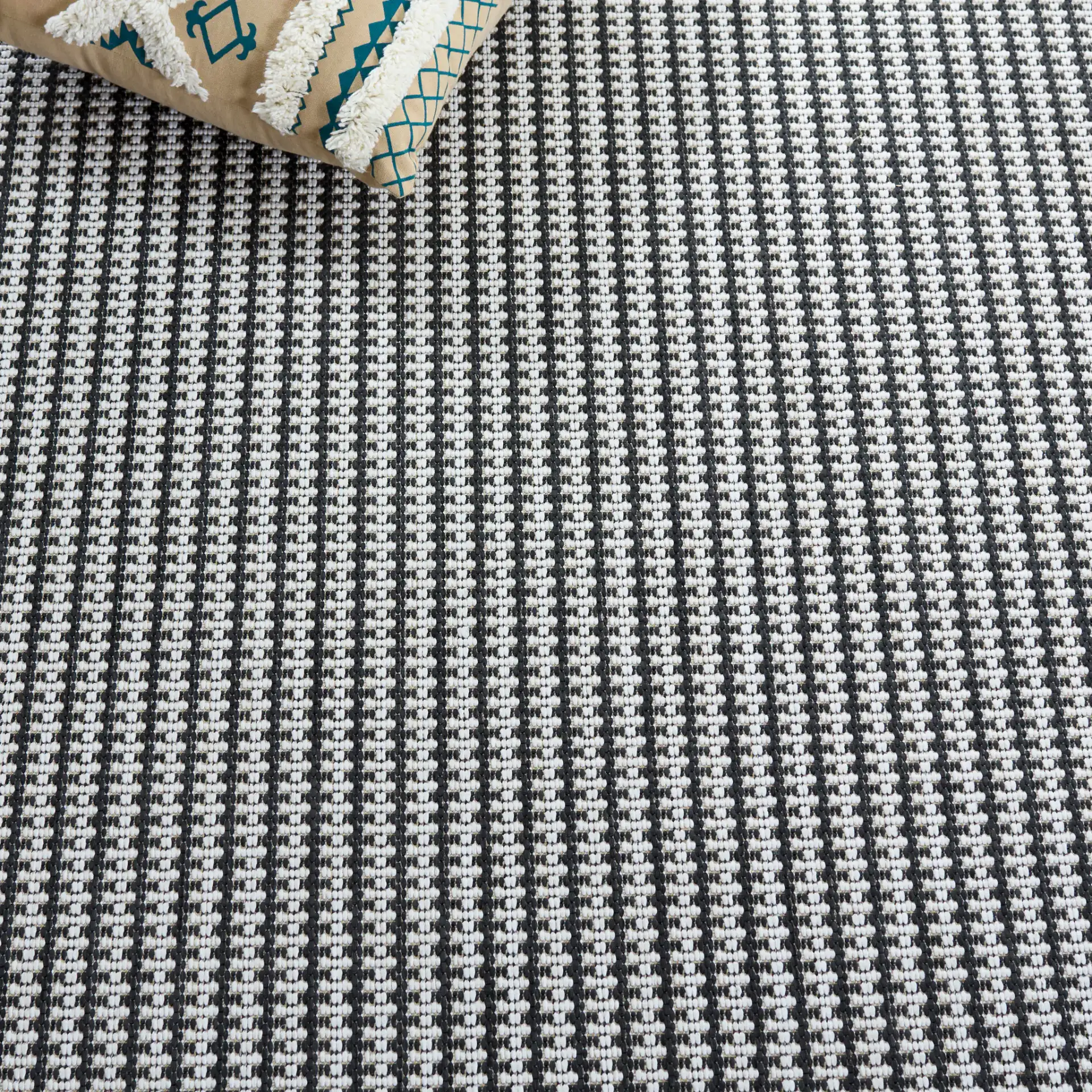 Terrace Basketweave Outdoor Rug in Black / White in a styled room