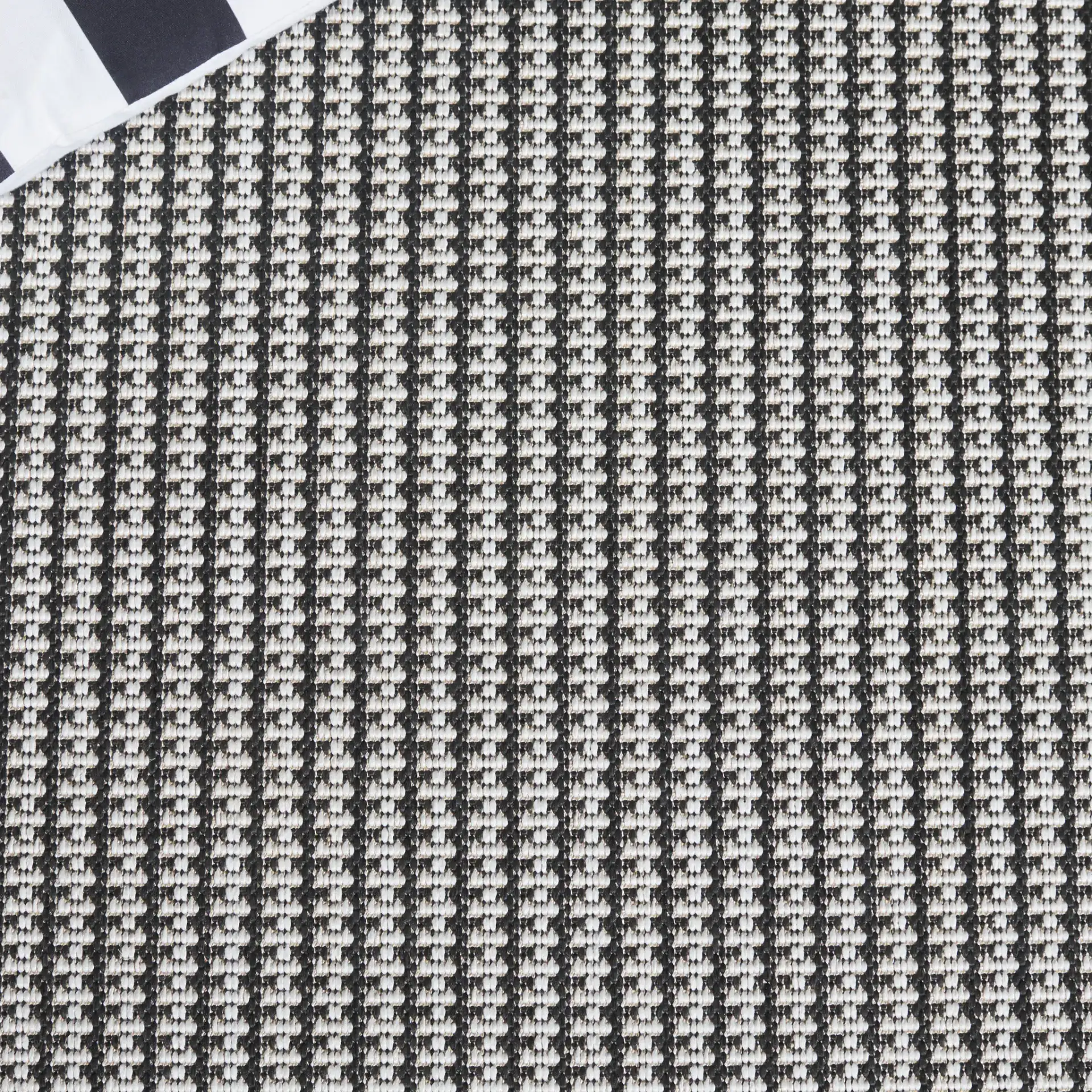 Terrace Basketweave Outdoor Rug in Black / White in a styled room
