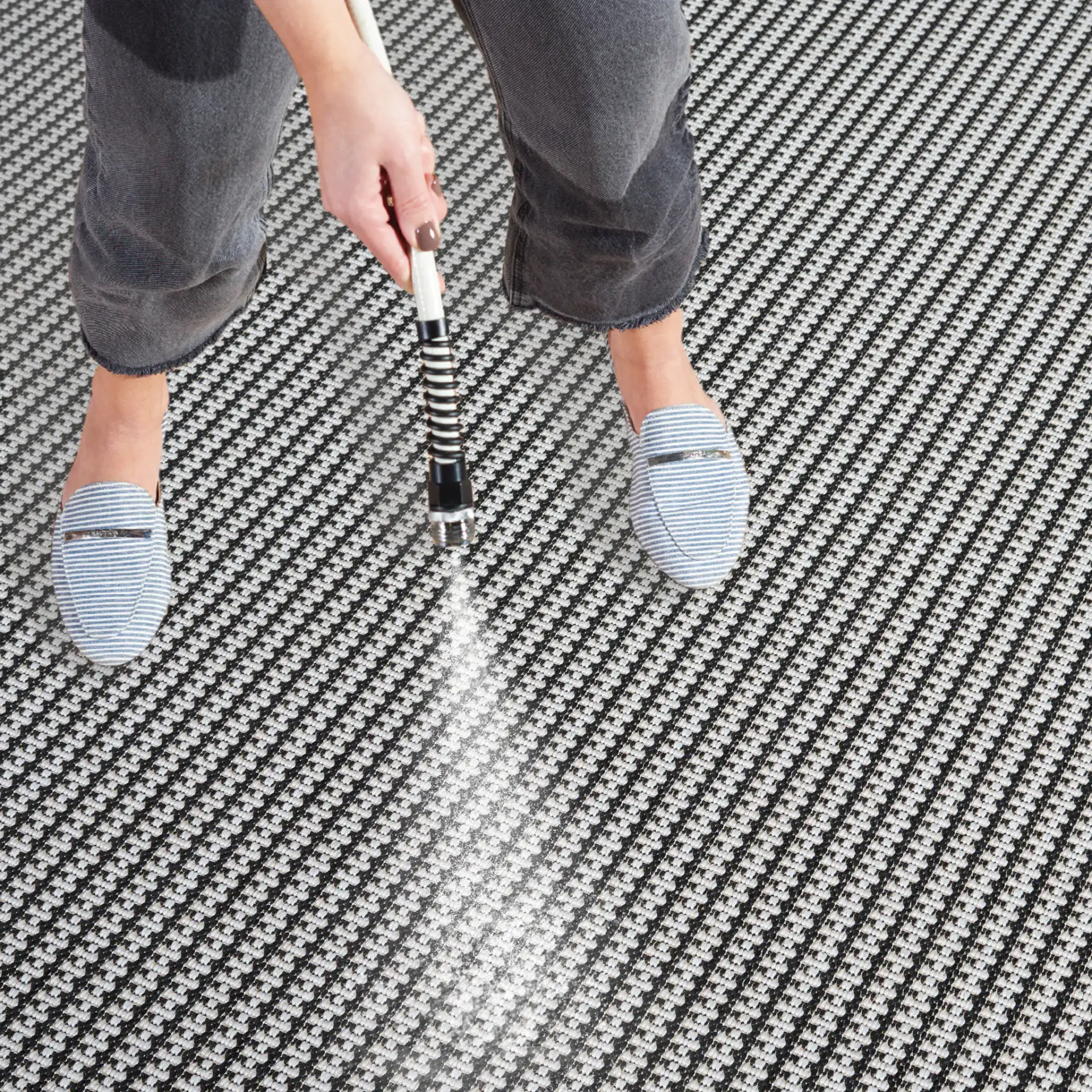 Terrace Basketweave Outdoor Rug in Black / White in a styled room