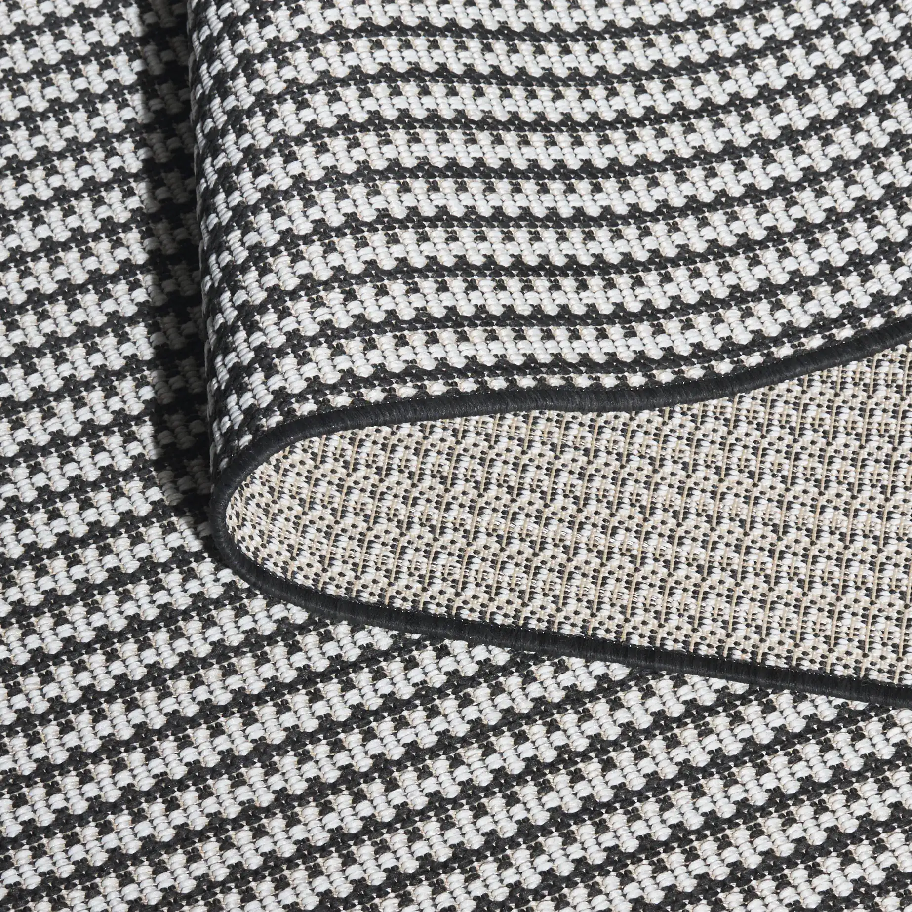 Terrace Basketweave Outdoor Rug in Black / White in a styled room