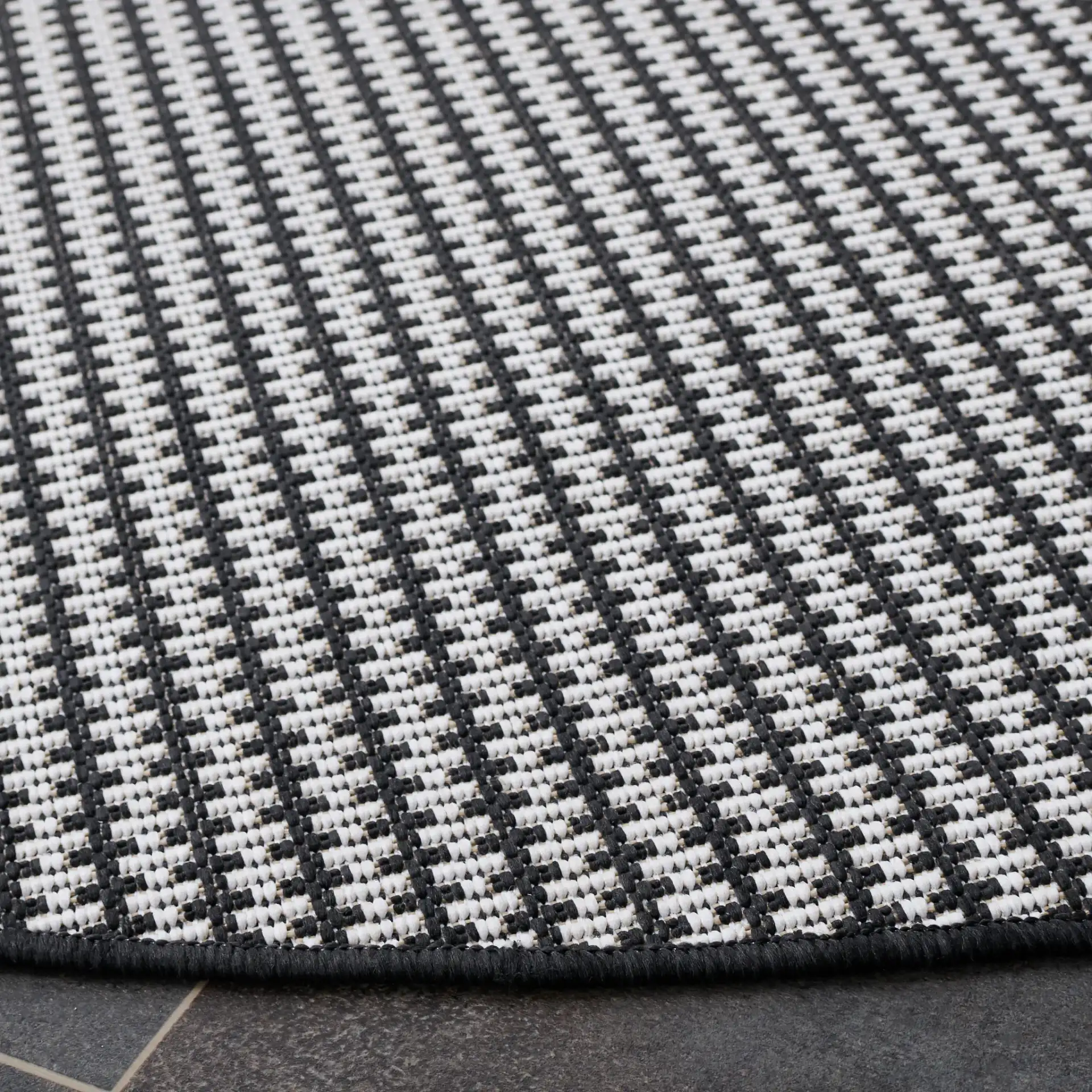Terrace Basketweave Outdoor Rug in Black / White in a styled room
