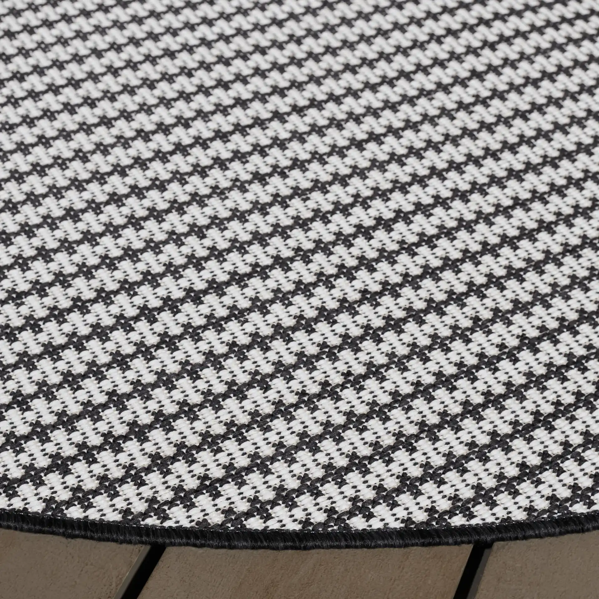 Terrace Basketweave Outdoor Rug in Black / White in a styled room